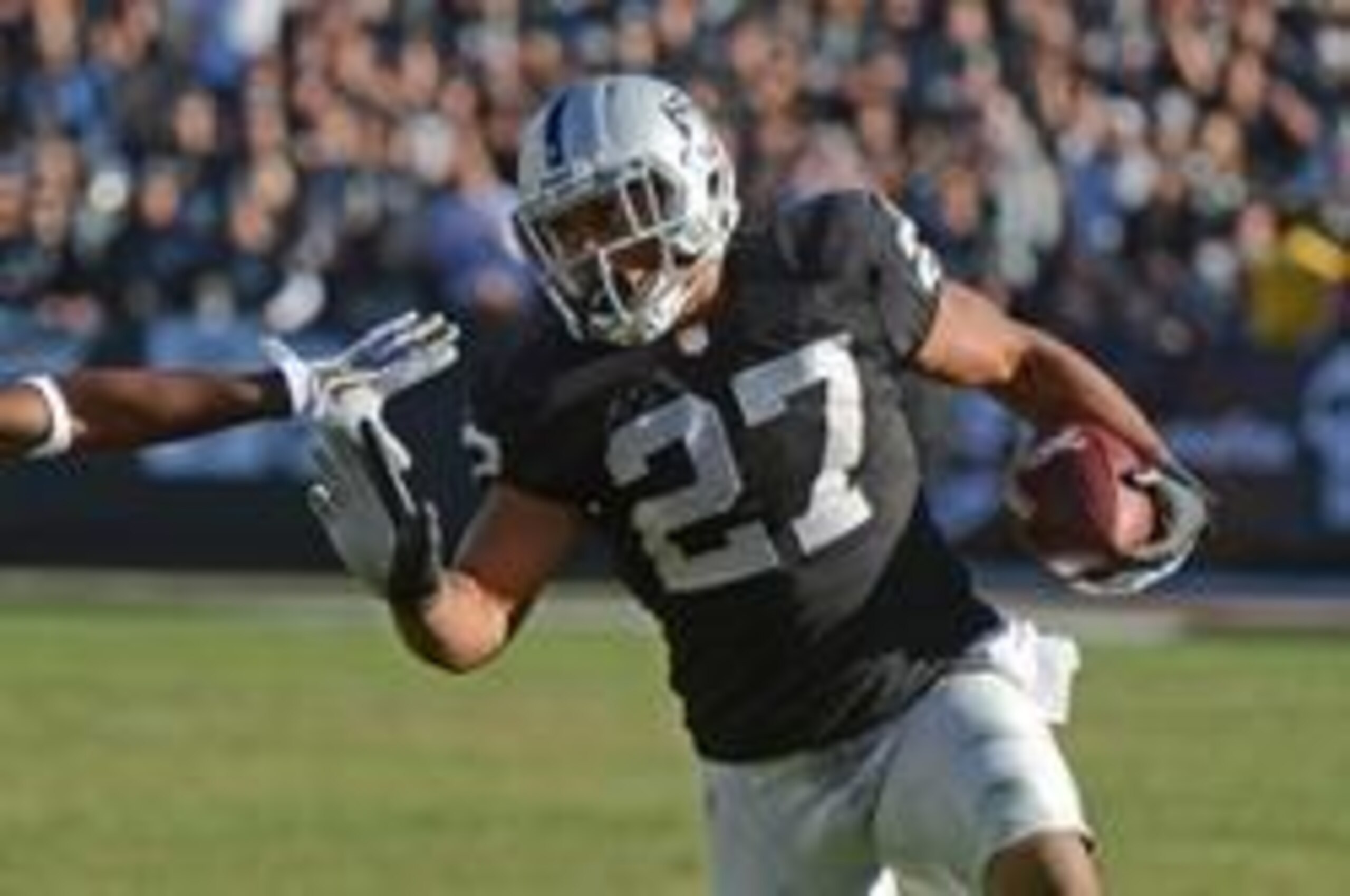 November 24, 2013; Oakland, CA, USA; Oakland Raiders running back Rashad Jennings (27) runs with the football during the second quarter against the Tennessee Titans at O.co Coliseum. The Titans defeated the Raiders 23-19. Mandatory Credit: Kyle Terada-USA