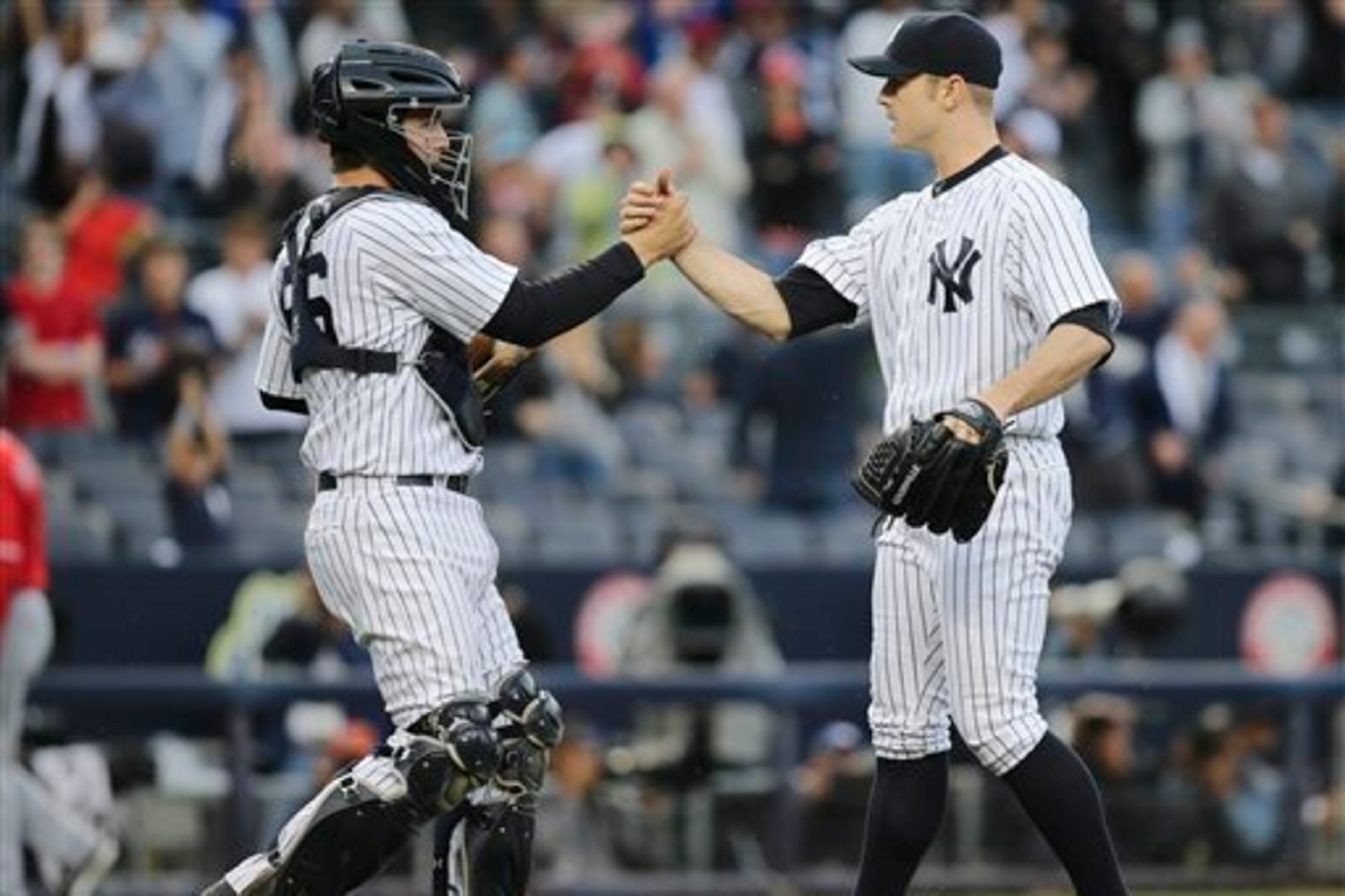 In an Apr. 26, 2014 win against the Angels, No. 3 prospect, catcher John Ryan Murphy (left), hit his first MLB home run and caught David Robertson's third save on the year.