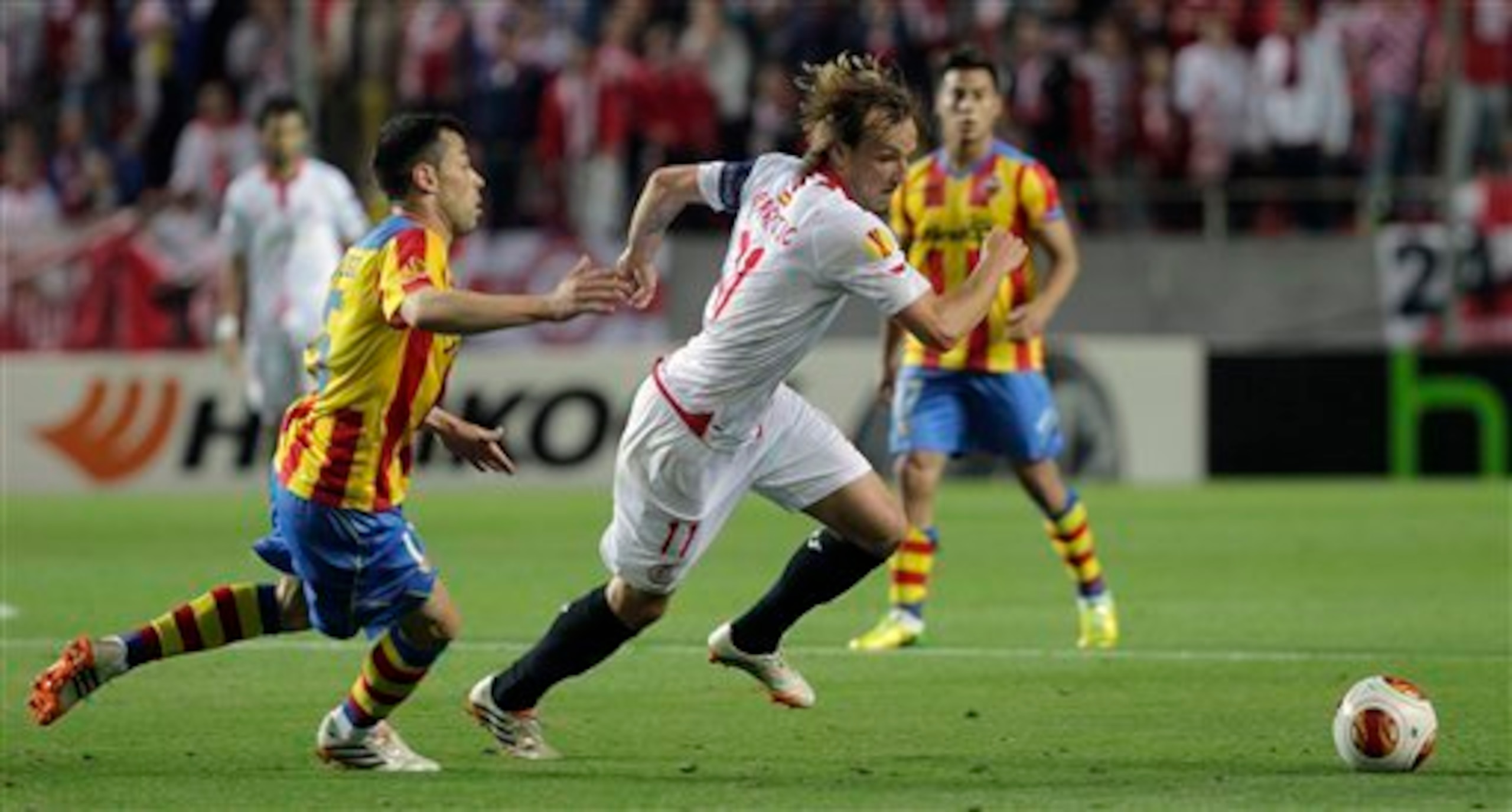 Sevilla's Ivan Rakitic, right, and Valencia's Javi Fuego, left, vie for the ball during their Europa League semifinal first leg soccer match at the Ramon Sanchez Pizjuan stadium, in Seville, Spain on Thursday, April 24, 2014. (AP Photo/Miguel Angel Morena Sevilla's Ivan Rakitic, right, and Valencia's Javi Fuego, left, vie for the ball during their Europa League semifinal first leg soccer match at the Ramon Sanchez Pizjuan stadium, in Seville, Spain on Thursday, April 24, 2014. (AP Photo/Miguel Angel Morena