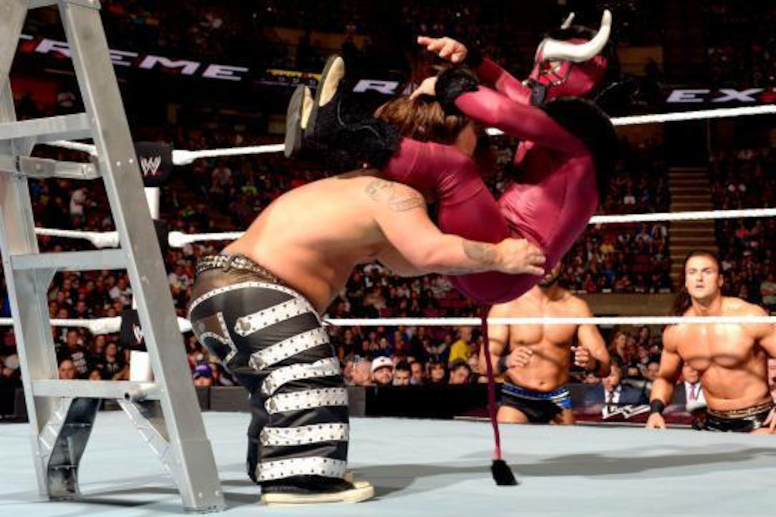 Hornswoggle powerbombs El Torito to the mat.