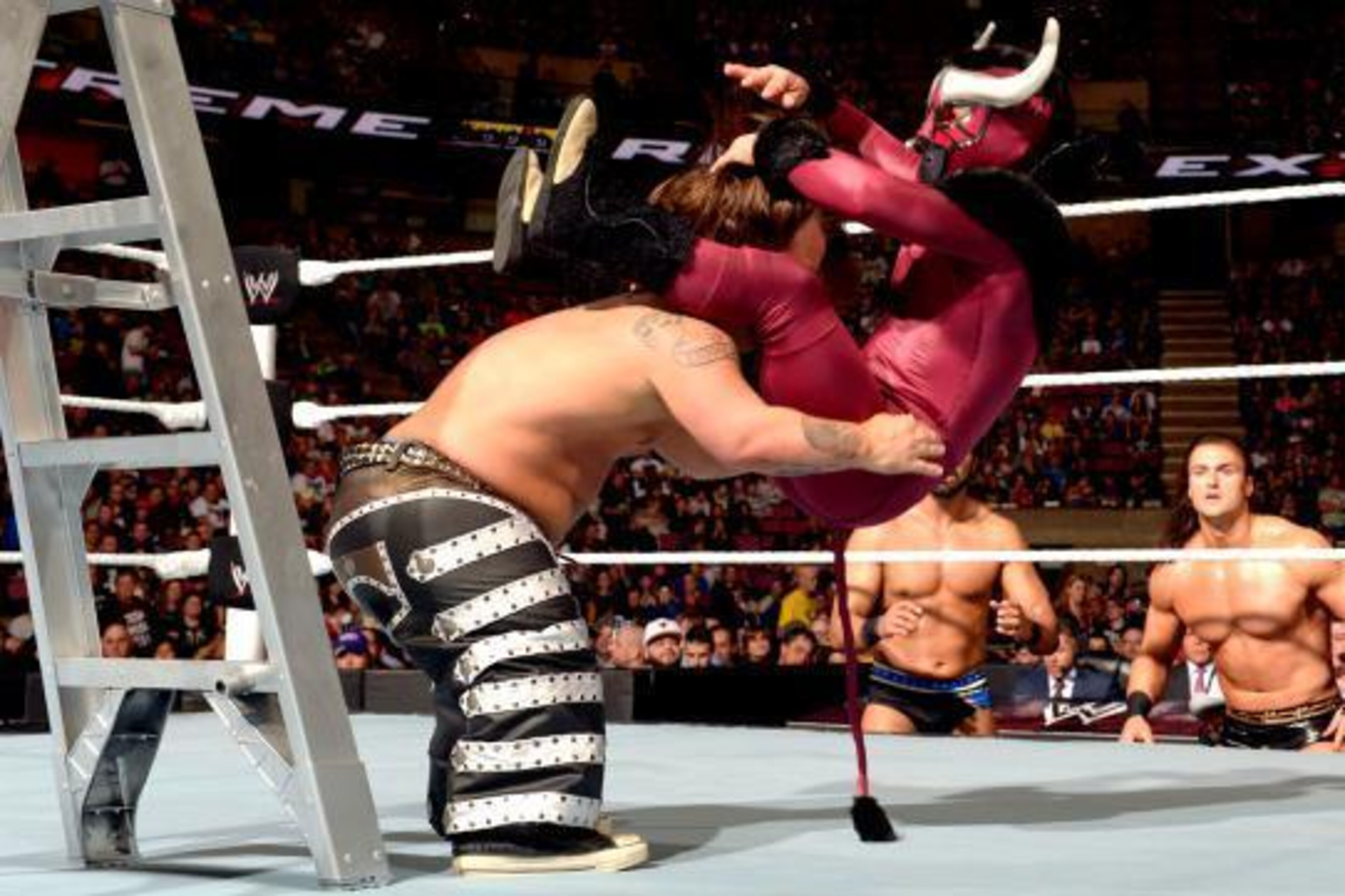 Hornswoggle powerbombs El Torito to the mat.