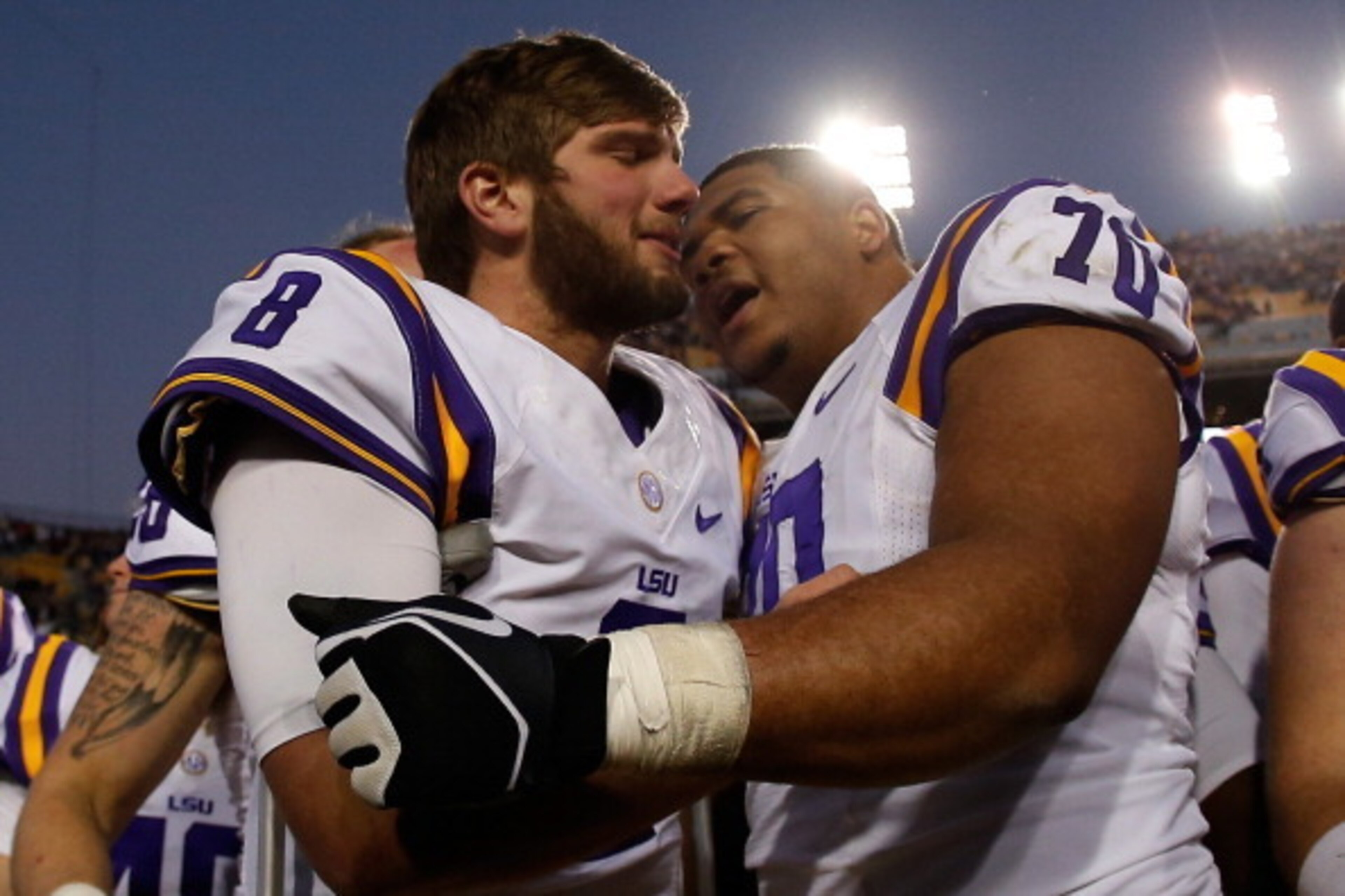 LSU left tackle La'el Collins (No. 70) embraces injured quarterback Zach Mettenberger after LSU's victory against Arkansas last season.