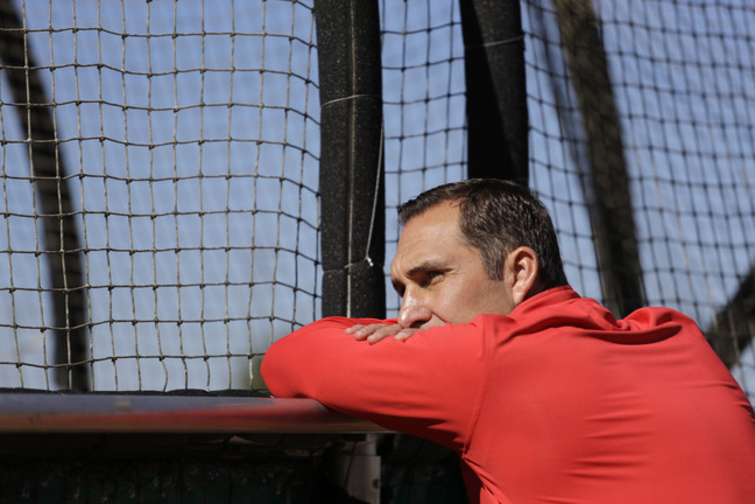 Cardinals GM John Mozeliak watches batting practice during spring training.