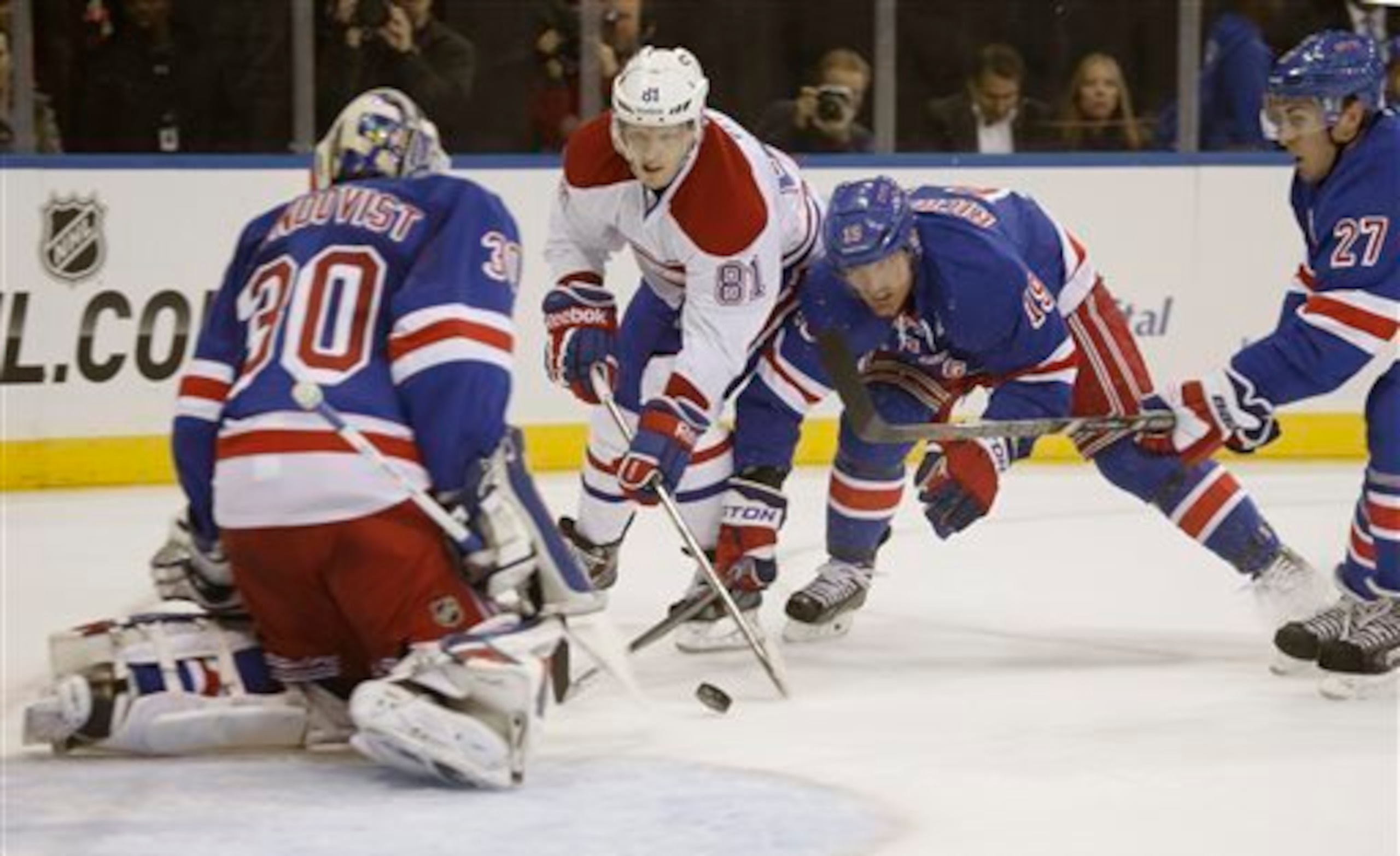 Montreal Canadiens forward Lars Eller moves in on New York Rangers goalie Henrik Lundqvist as Brad Richards and Ryan McDonagh look on.