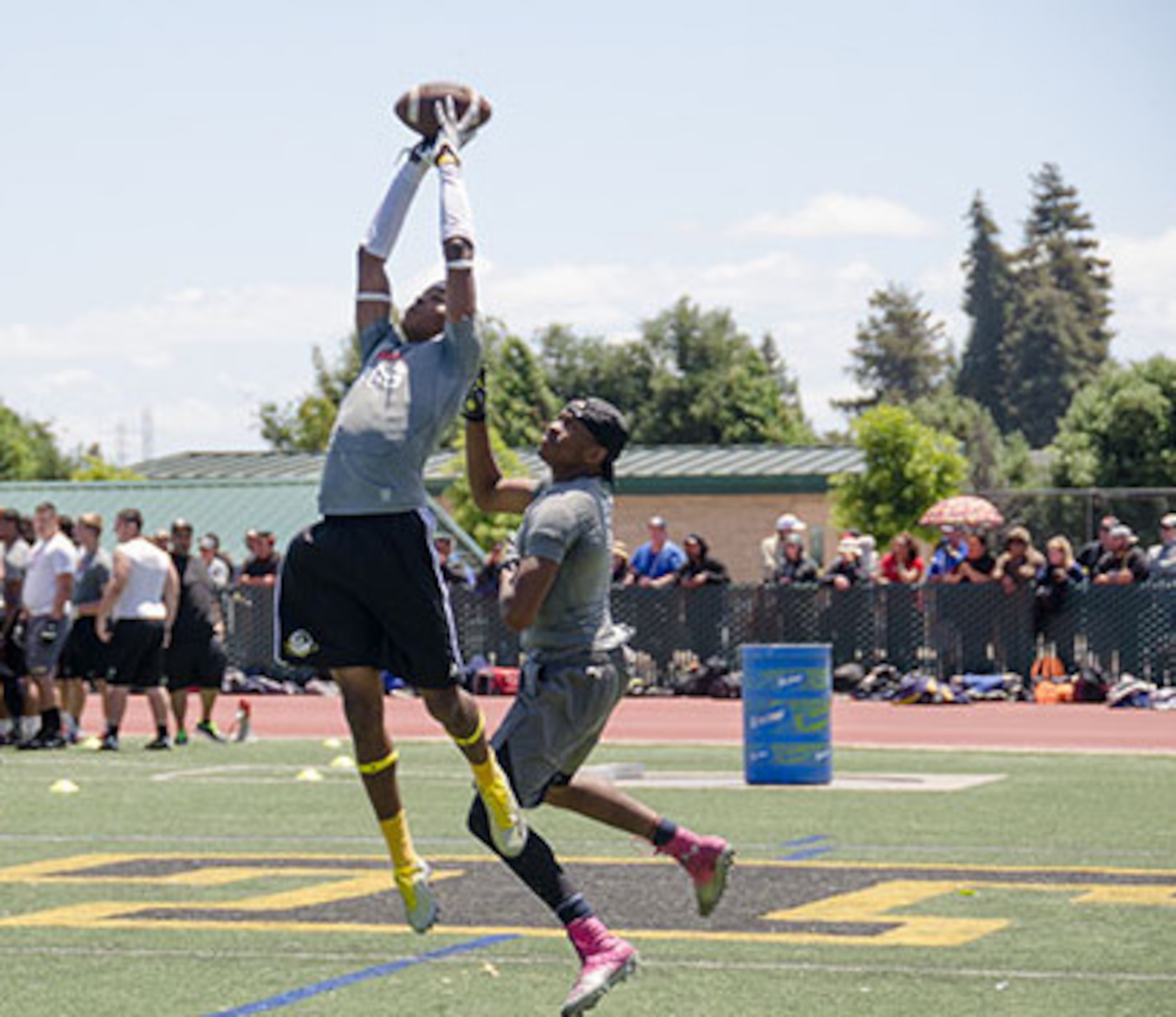 Isaiah Langley (yellow socks) snags an interception during drills on Sunday.