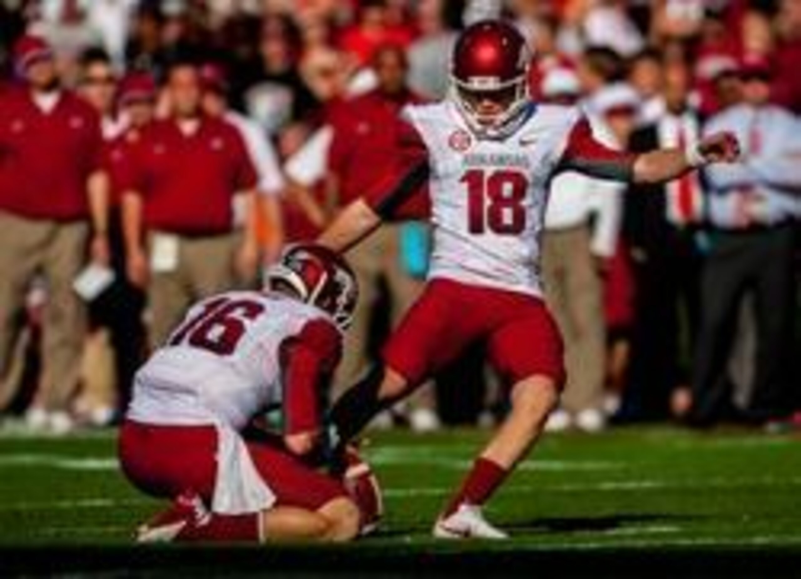 November 10, 2012; Columbia, SC, USA; Arkansas Razorbacks kicker Zach Hocker (18) kicks a field goal as quarterback Brian Buehner (16) holds in the second half against the South Carolina Gamecocks at Williams-Brice Stadium. Mandatory Credit: Jeff Blake-US
