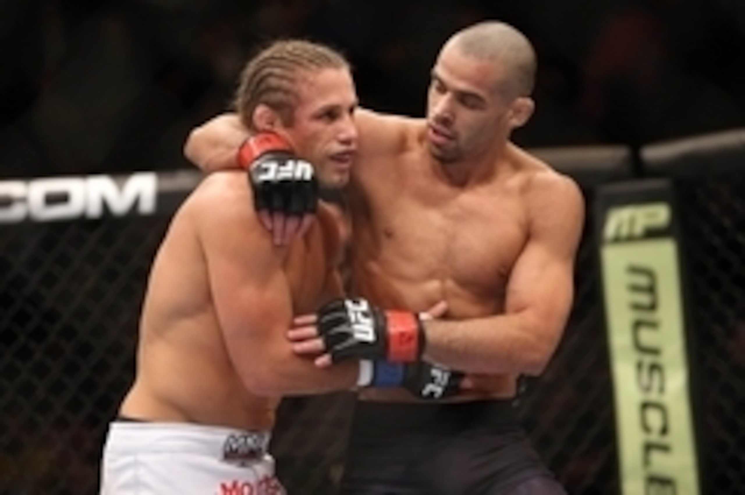 Renan Barao consoles Urijah Faber (left) after Faber's loss to Barao.