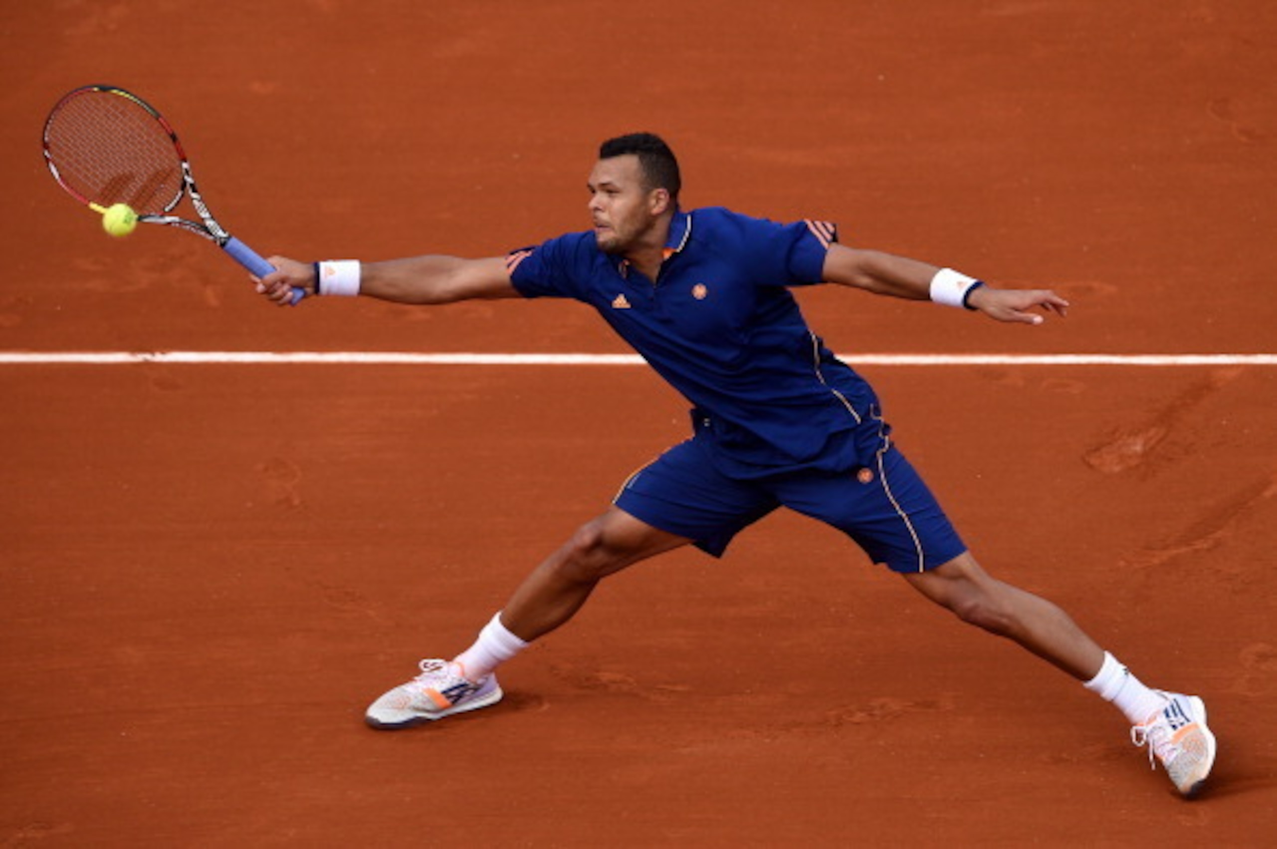 Jo-Wilfried Tsonga slides toward the ball during his first-round match at the 2014 French Open.