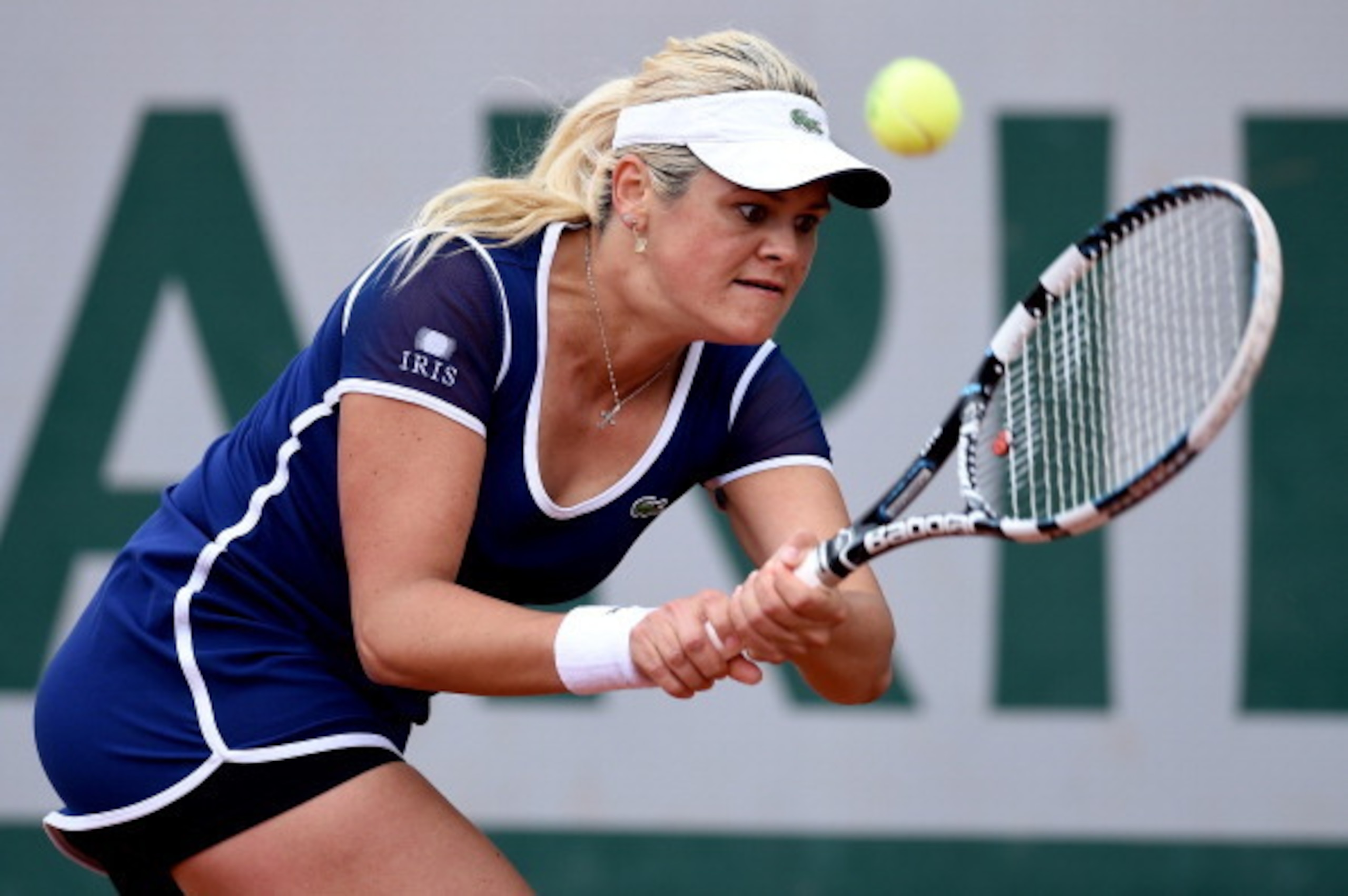 Aleksandra Wozniak goes for her backhand during a match at the 2014 French Open.