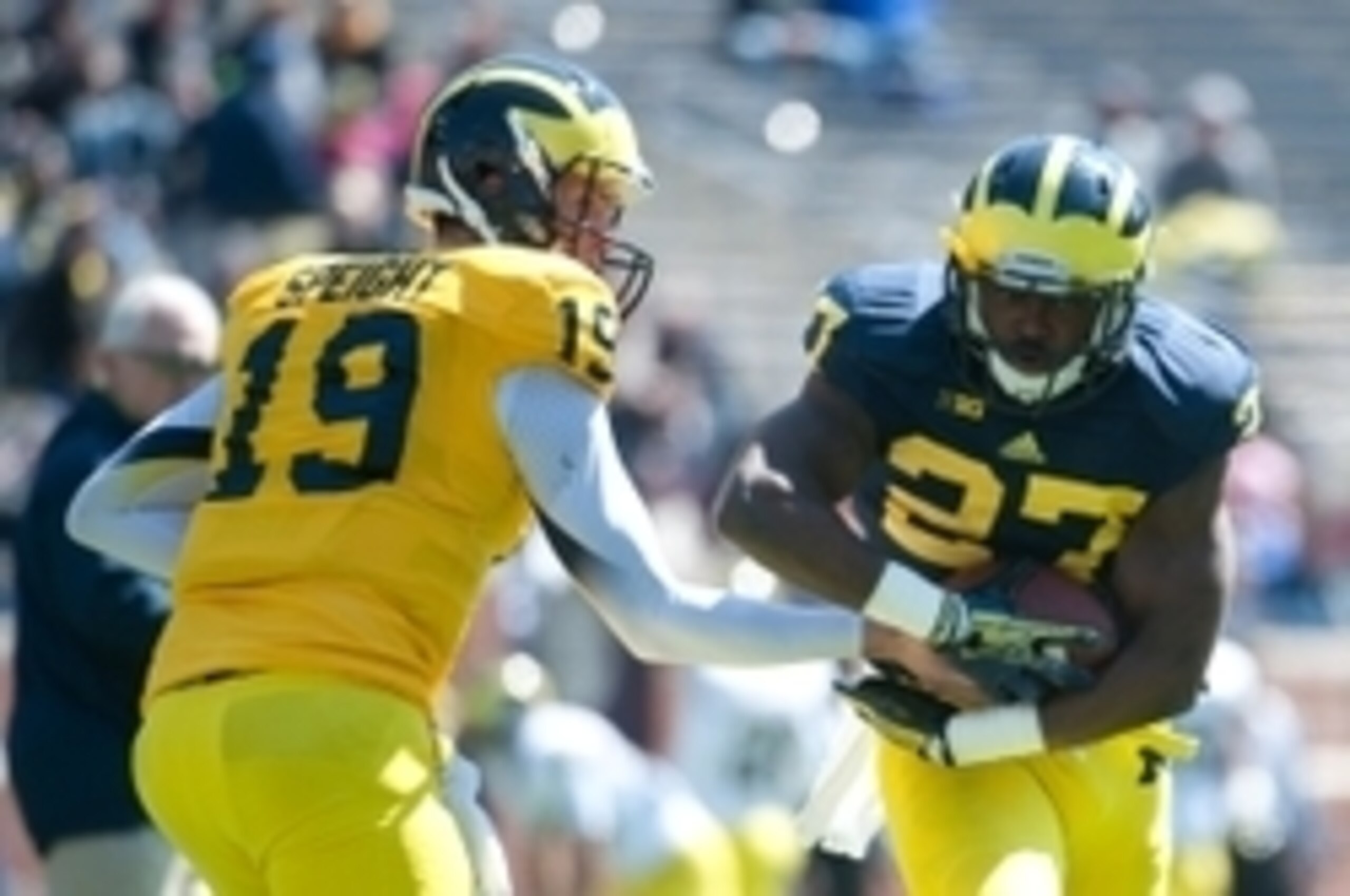 Apr 5, 2014; Ann Arbor, MI, USA; Michigan Wolverines quarterback Wilton Speight (19) hands the ball off to running back Derrick Green (27) prior to the Spring Game at Michigan Stadium. Mandatory Credit: Tim Fuller-USA TODAY Sports