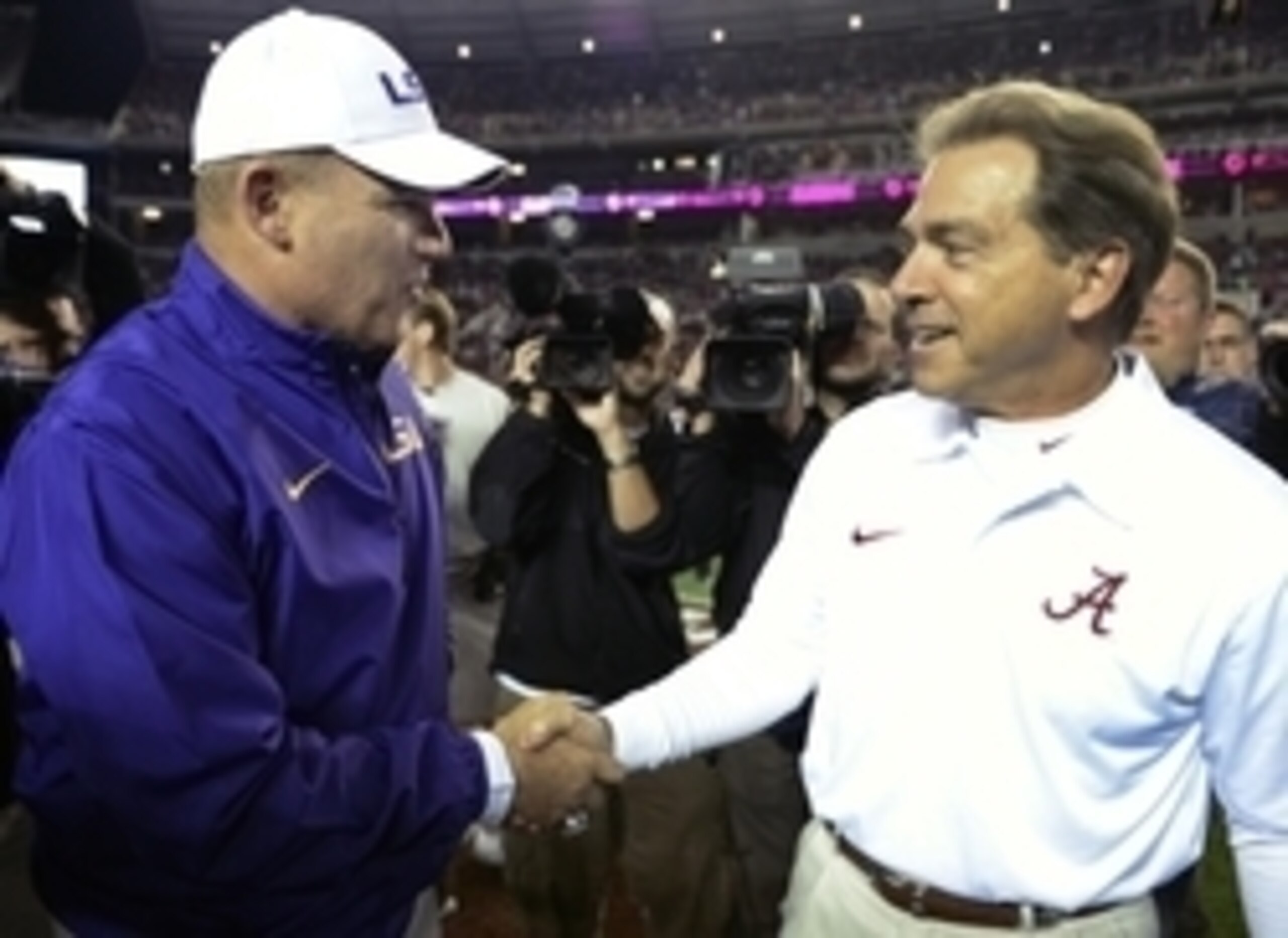 Nov 9, 2013; Tuscaloosa, AL, USA; LSU Tigers head coach Les Miles and Alabama Crimson Tide head coach Nick Saban greet each other midfield before the start of their game at Bryant-Denny Stadium. Mandatory Credit: John David Mercer-USA TODAY Sports