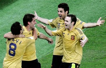 Spain's Xavi Hernandez, left, is congratulated by his teammates, from right, Andres Iniesta, Cesc Fabregas and Joan Capdevila after scoring the opening goal during the semifinal match between Russia and Spain in Vienna, Austria, Thursday, June 26, 2008, a
