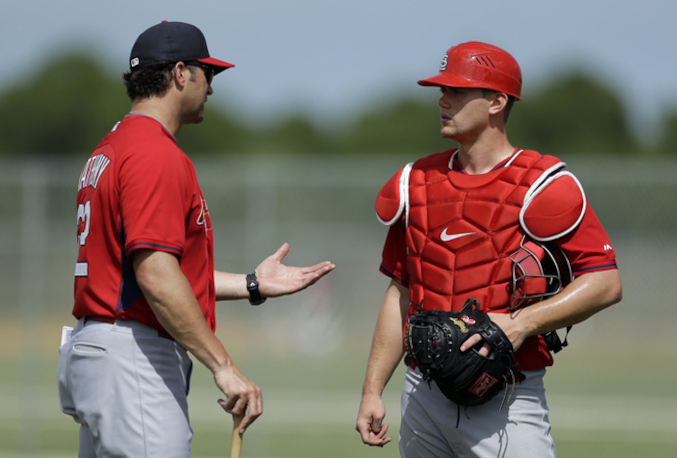 Manager Mike Matheny instructing Carson Kelly during spring training in March