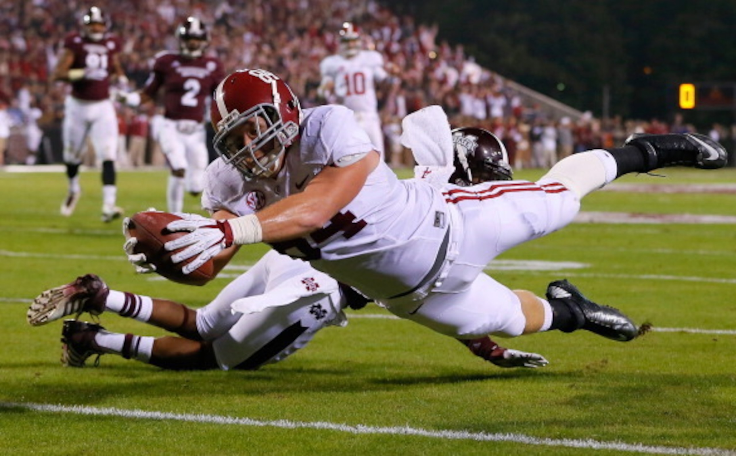 STARKVILLE, MS - NOVEMBER 16: Brian Vogler #84 of the Alabama Crimson Tide dives for a touchdown against Jamerson Love #5 of the Mississippi State Bulldogs at Davis Wade Stadium on November 16, 2013 in Starkville, Mississippi. (Photo by Kevin C. Cox/Get STARKVILLE, MS - NOVEMBER 16: Brian Vogler #84 of the Alabama Crimson Tide dives for a touchdown against Jamerson Love #5 of the Mississippi State Bulldogs at Davis Wade Stadium on November 16, 2013 in Starkville, Mississippi. (Photo by Kevin C. Cox/Get