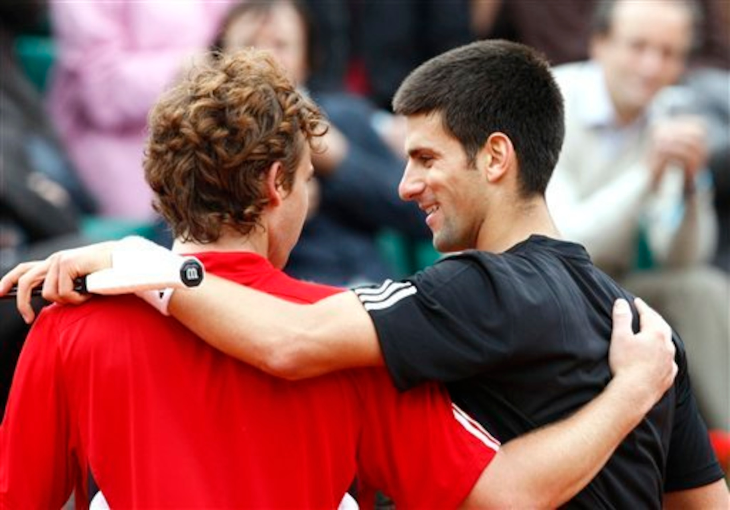 Novak Djokovic embraces a young Ernests Gulbis after defeating him in the 2008 French Open.