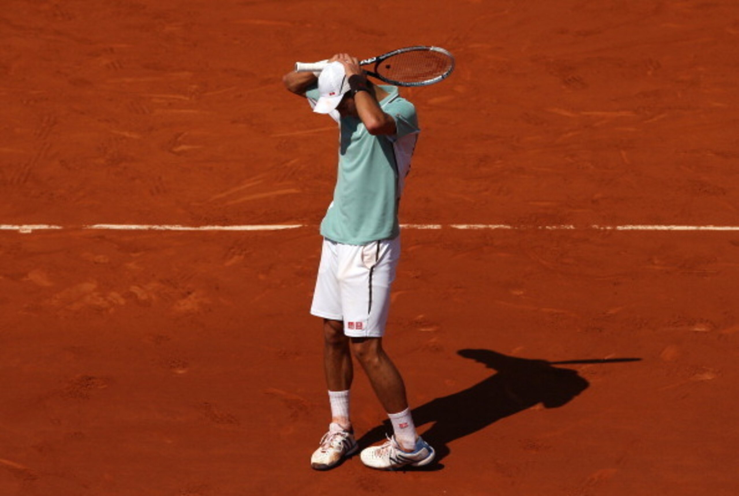 A disappointed Novak Djokovic reacts to losing to Rafael Nadal at the 2013 French Open.