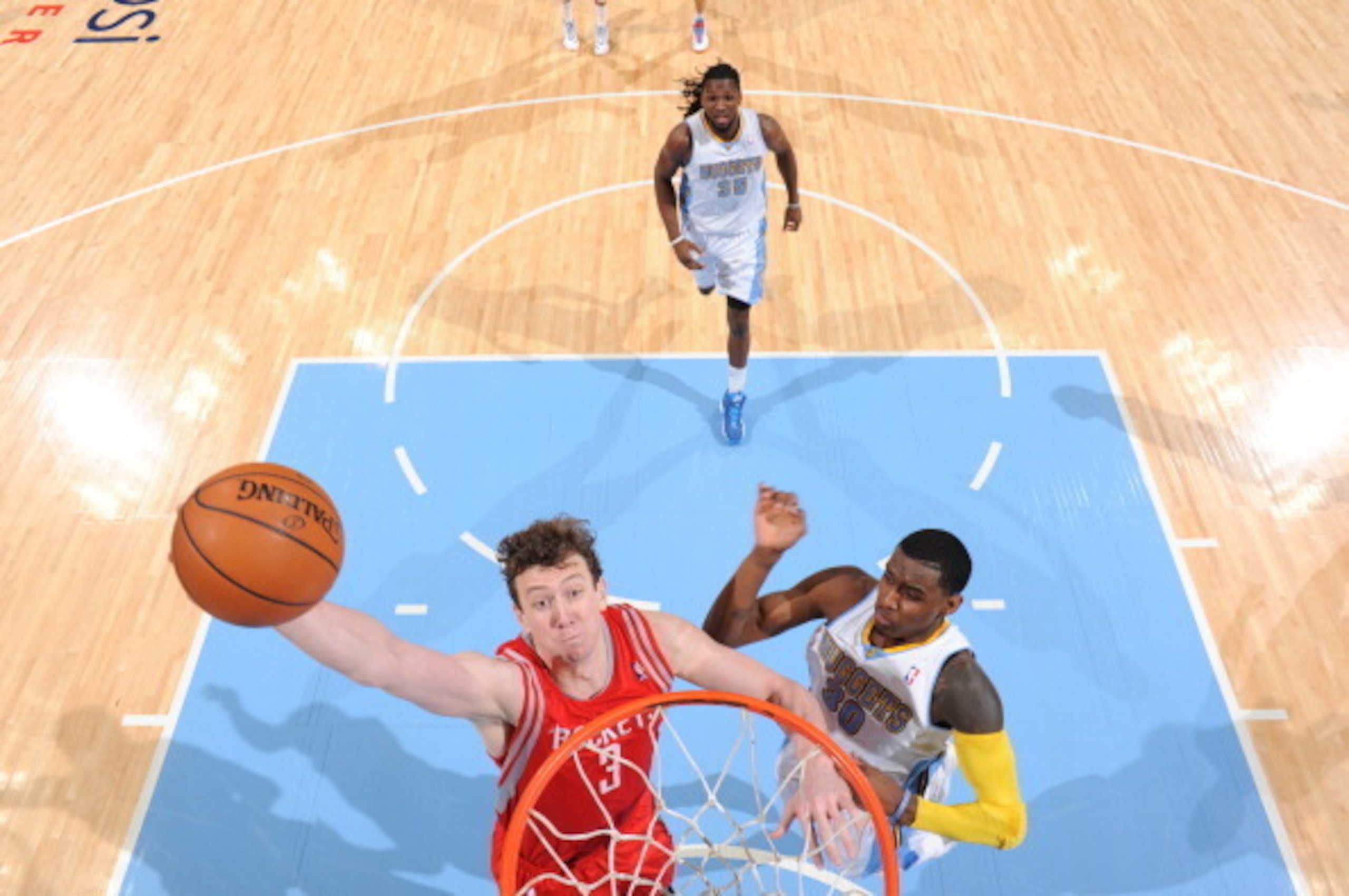 Omer Asik of the Houston Rockets throws down a dunk against the Nuggets defense.