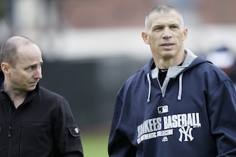 GM Brian Cashman (left), skipper Joe Girardi (right) and the Yankees sacrificed their first- and compensation-round picks in the 2014 MLB draft. With selections at No. 55 and 91, and a deep class of prospects, however, it's hardly time to hit the panic button in the Bronx.