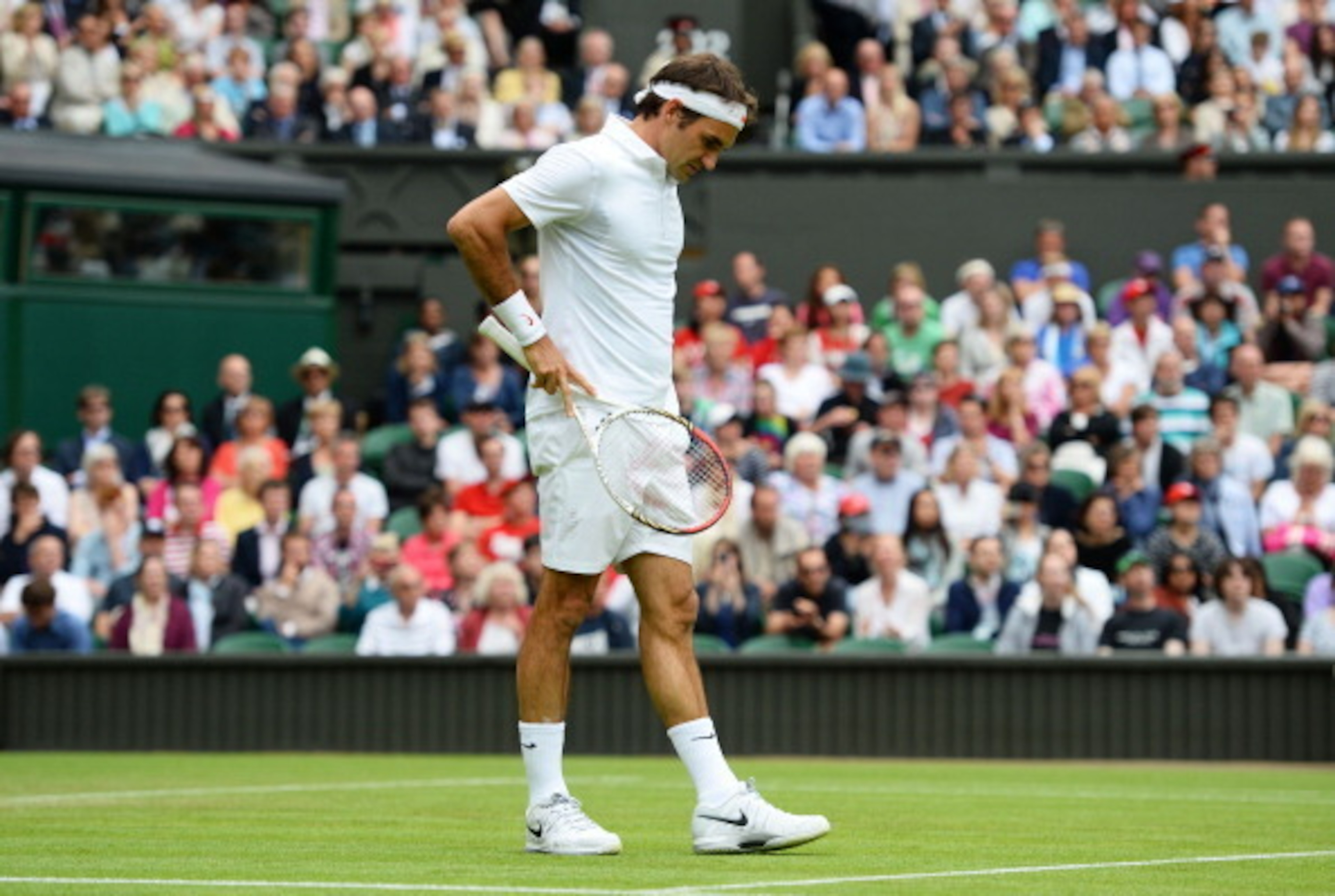 Roger Federer appears frustrated in his match during the 2013 Wimbledon championships.