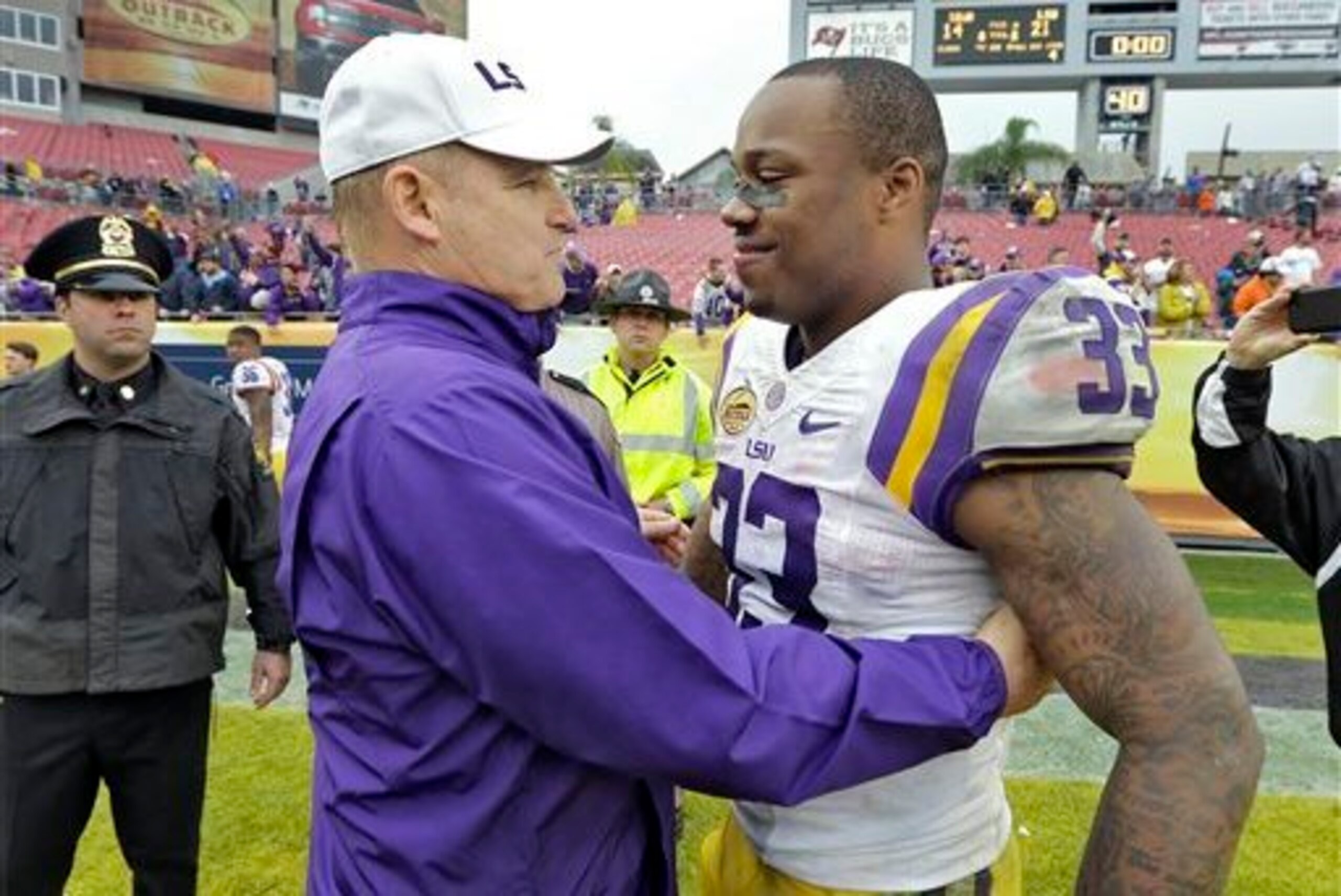 LSU head coach Les Miles shares a moment with Jeremy Hill (right) after the 2014 Outback Bowl victory.