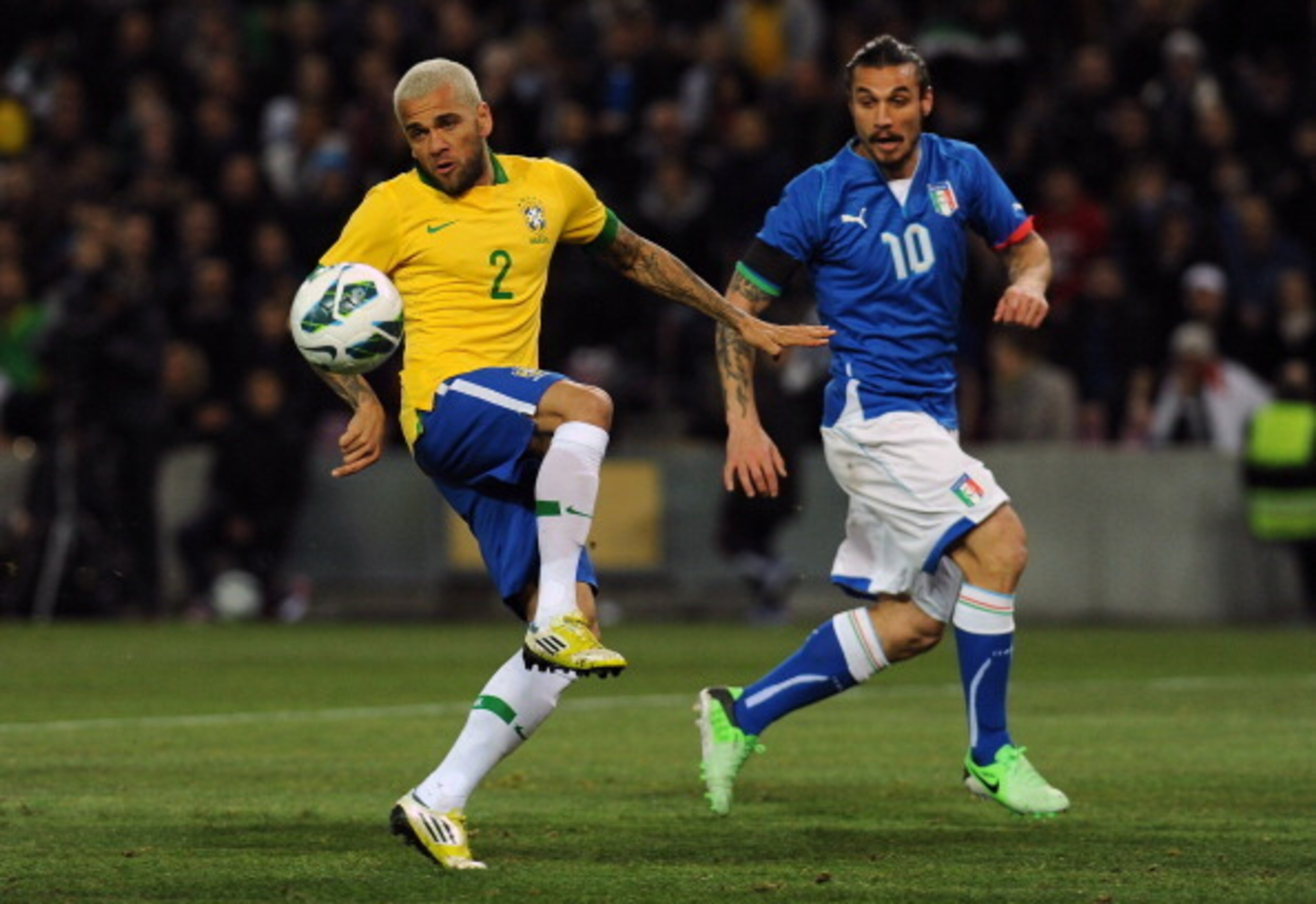 Dani Alves controls the ball in action against Italy.