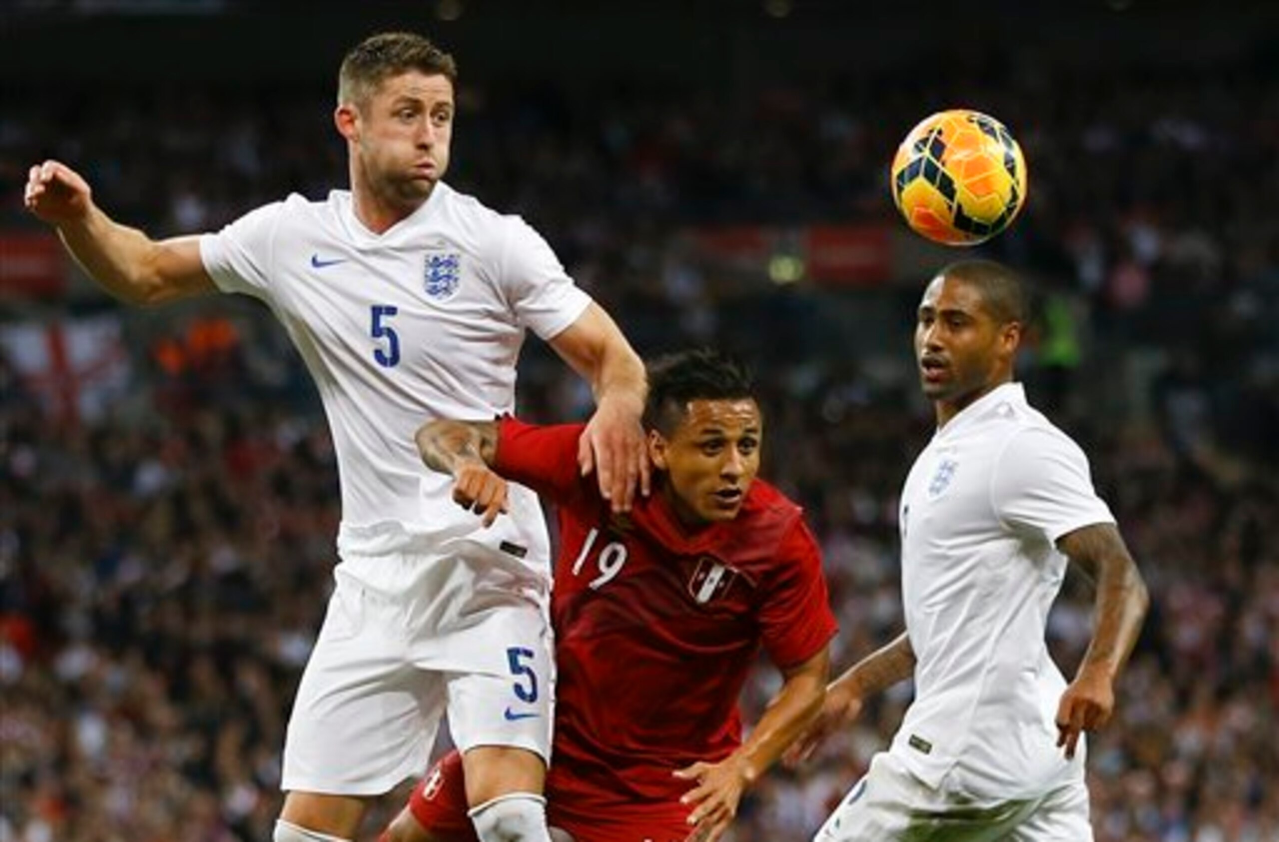 England's Gary Cahill heads in his goal against Peru.