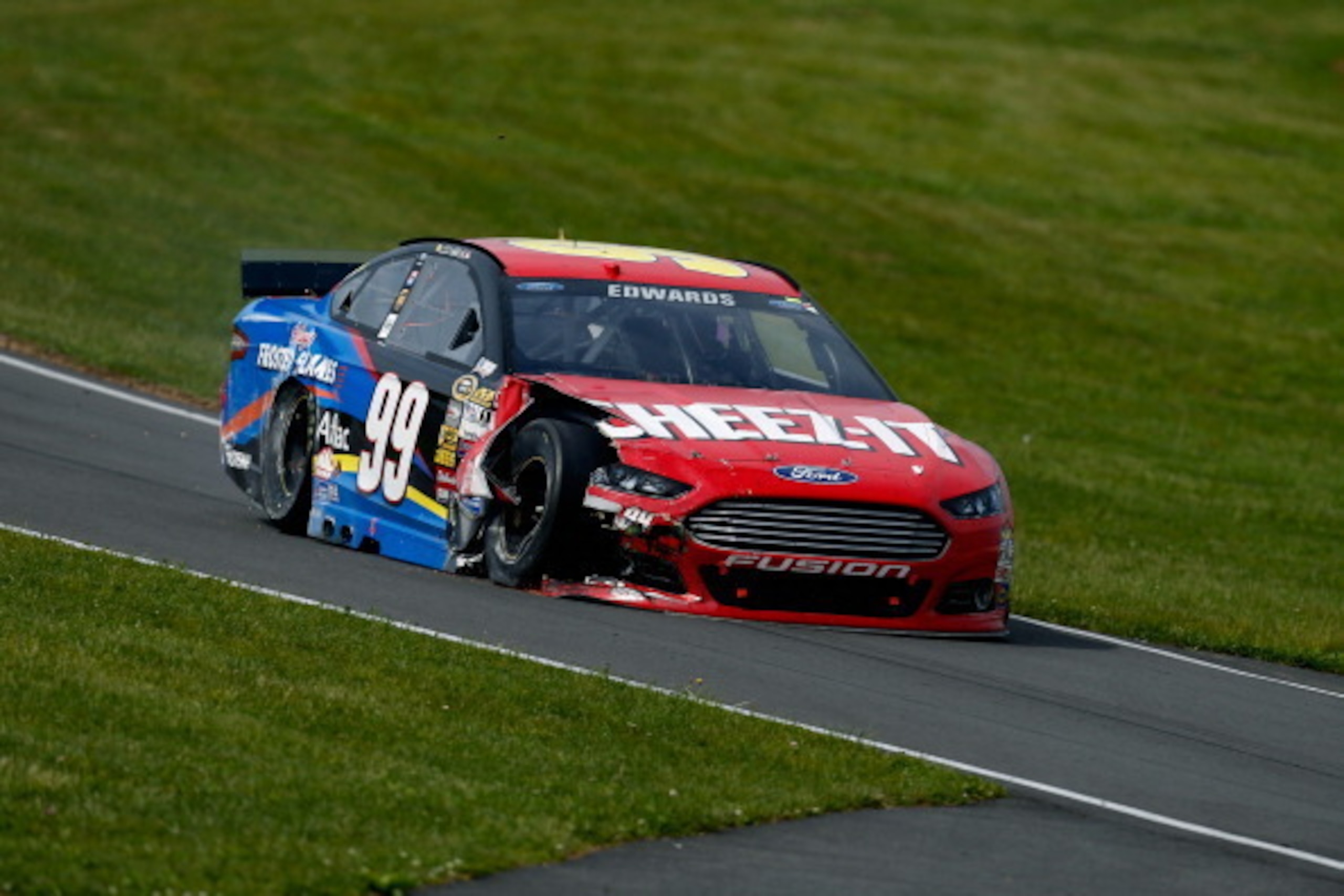 LONG POND, PA - JUNE 08: Carl Edwards, driver of the #99 Kelloggs/Cheez-It Ford, drives back to the garage area after an on-track incident during the NASCAR Sprint Cup Series Pocono 400 at Pocono Raceway on June 8, 2014 in Long Pond, Pennsylvania. (Phot LONG POND, PA - JUNE 08: Carl Edwards, driver of the #99 Kelloggs/Cheez-It Ford, drives back to the garage area after an on-track incident during the NASCAR Sprint Cup Series Pocono 400 at Pocono Raceway on June 8, 2014 in Long Pond, Pennsylvania. (Phot