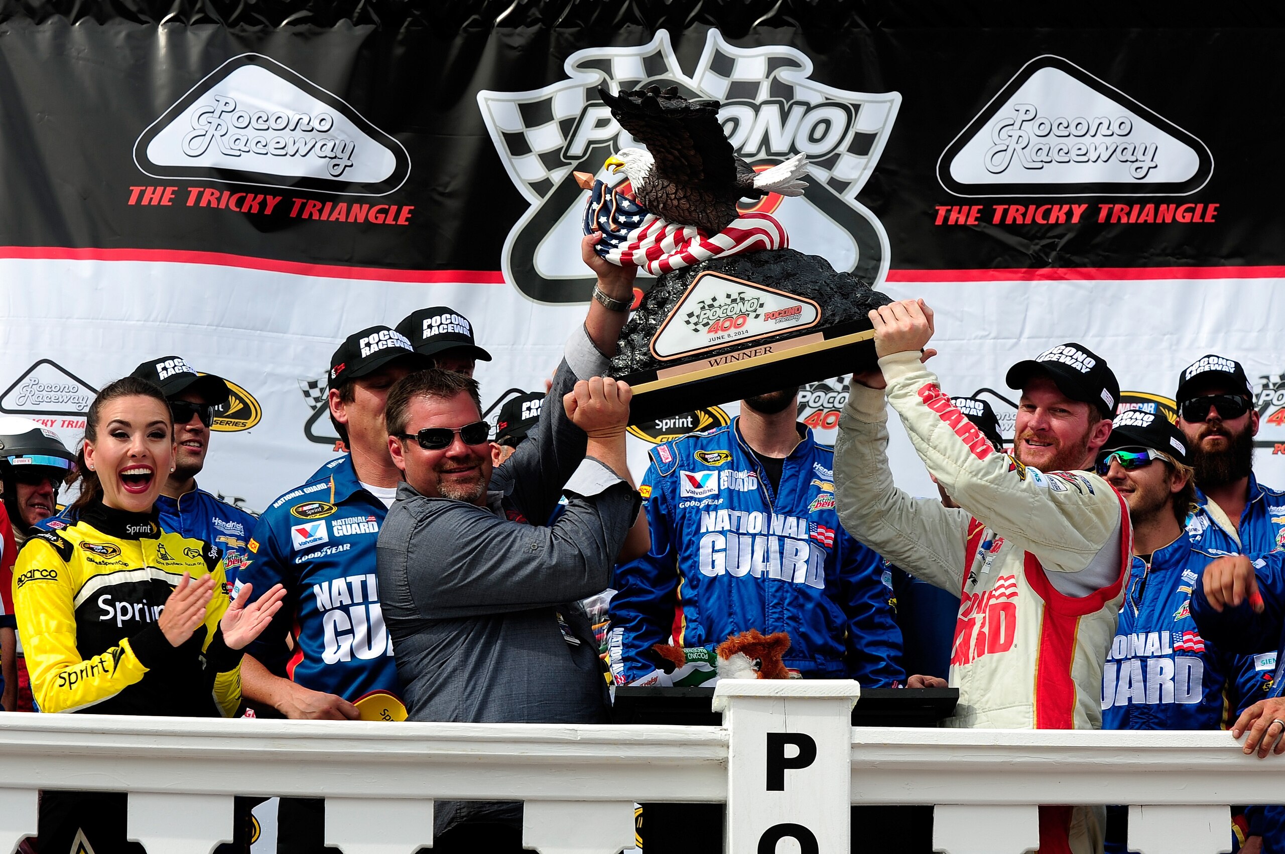 Dale Earnhardt Jr. (right) hoists the new Pocono Raceway trophy in Victory Lane. Dale Earnhardt Jr. (right) hoists the new Pocono Raceway trophy in Victory Lane.