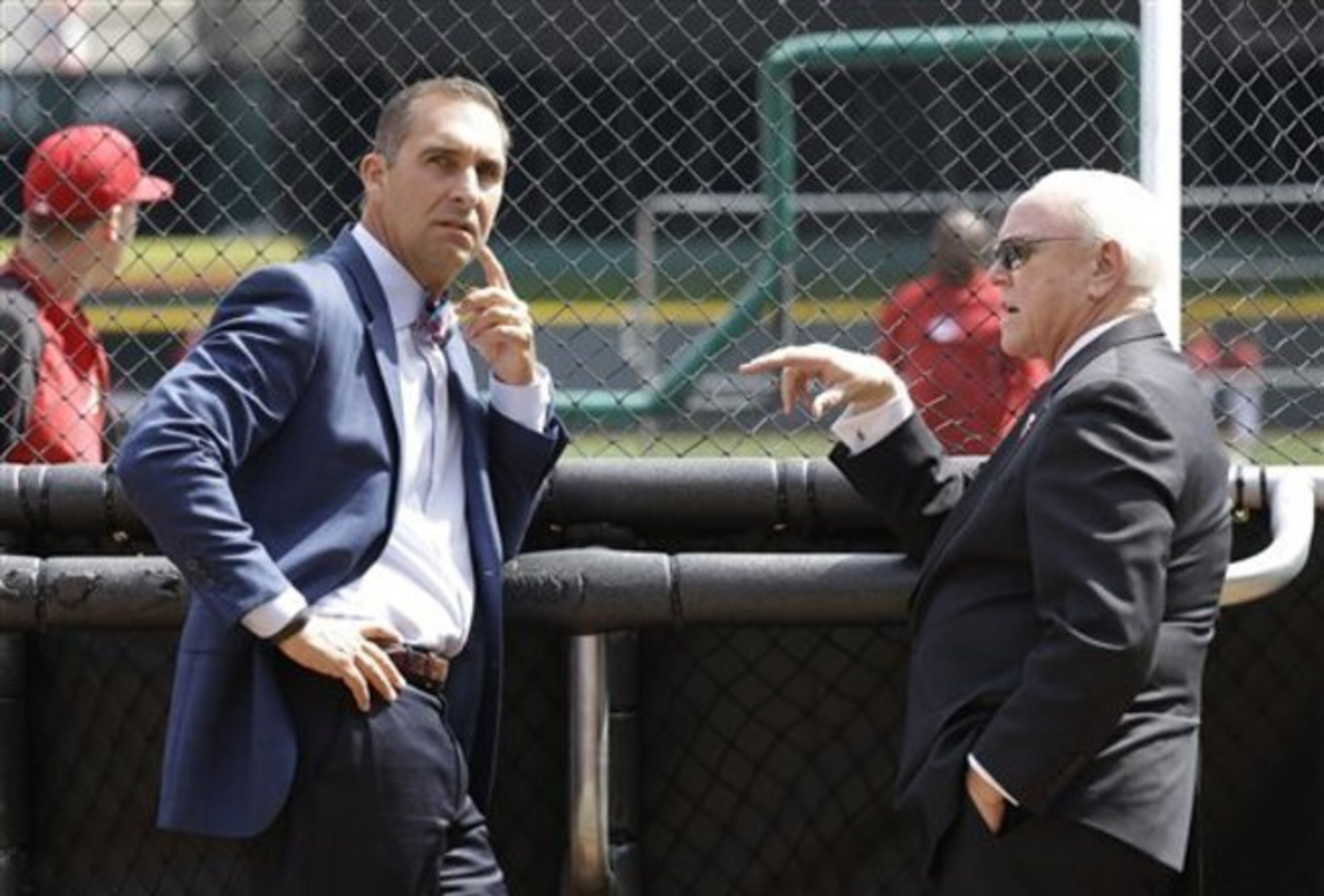 Cardinals GM John Mozeliak (left) watches batting practice before a game against Cincinnati on March 31.