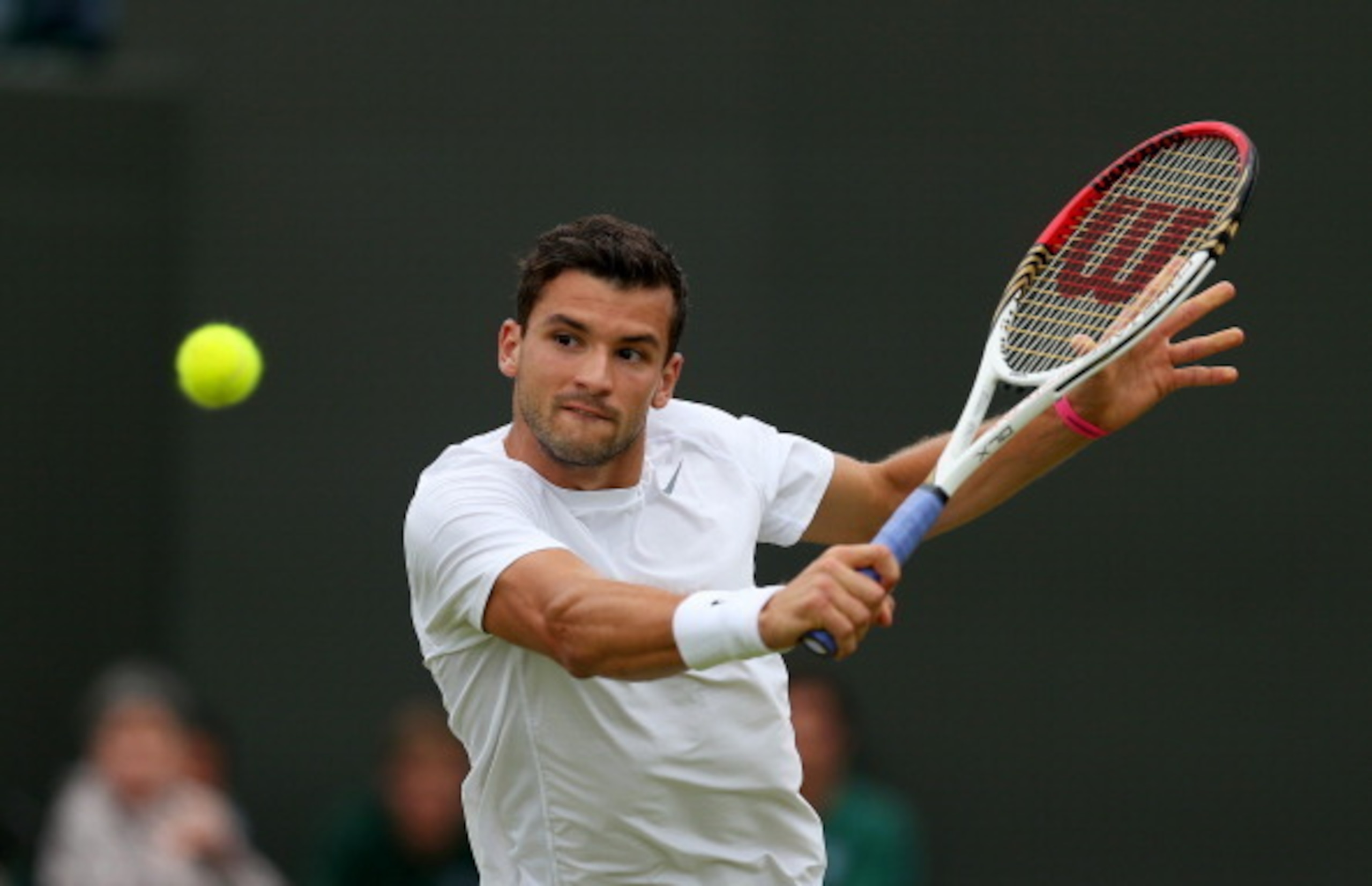 Grigor Dimitrov prepares to hit a backhand volley during a Wimbledon match in 2013.