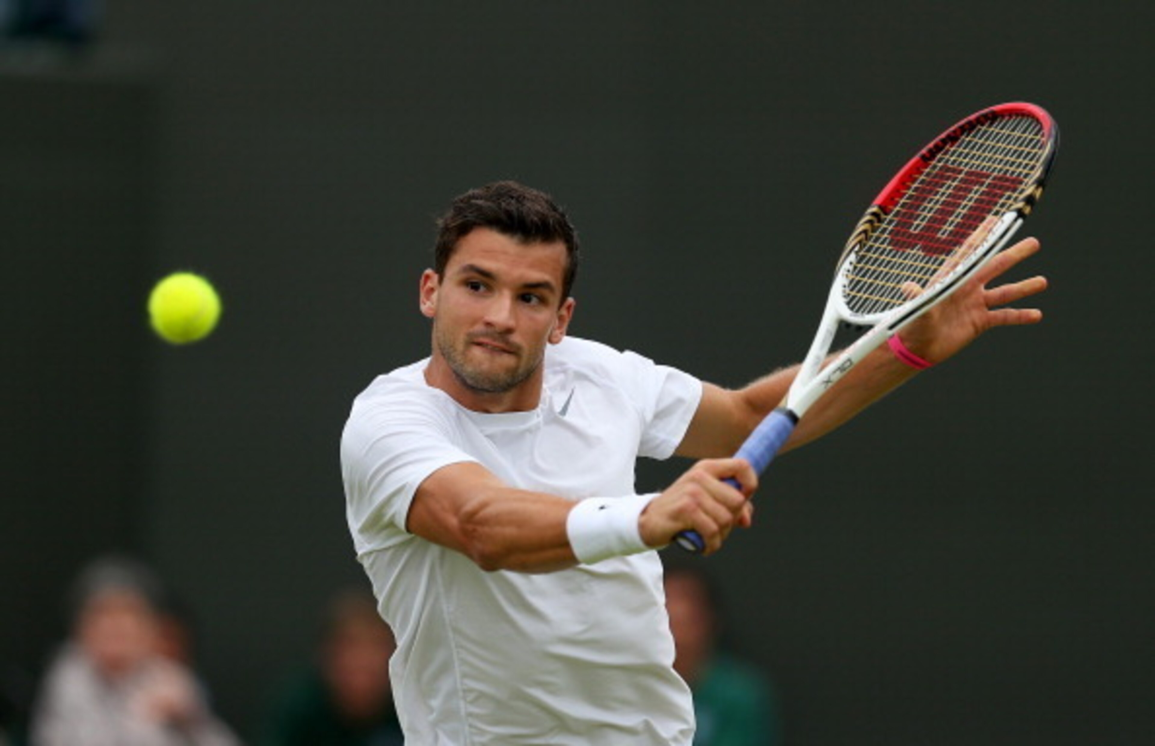 Grigor Dimitrov prepares to hit a backhand volley during a Wimbledon match in 2013.