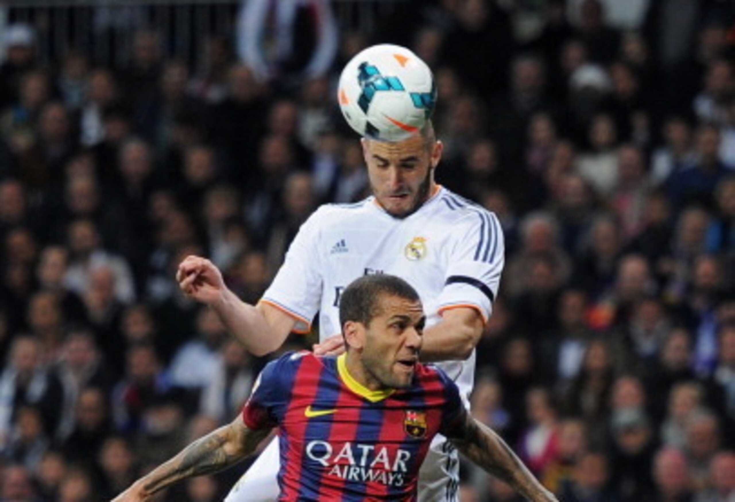 MADRID, SPAIN - MARCH 23:  Karim Benzema of Real Madrid wins a header from Daniel Alves of Barcelona during the La Liga match between Real Madrid CF and FC Barcelona at the Bernabeu on March 23, 2014 in Madrid, Spain.  (Photo by Denis Doyle/Getty Images)