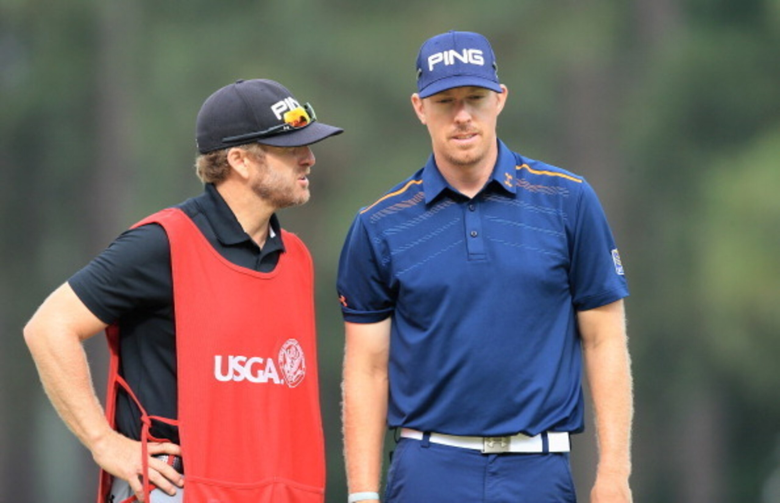 Caddie John Wood (left) consults with golfer Hunter Mahan after Friday's unthinkable gaffe.