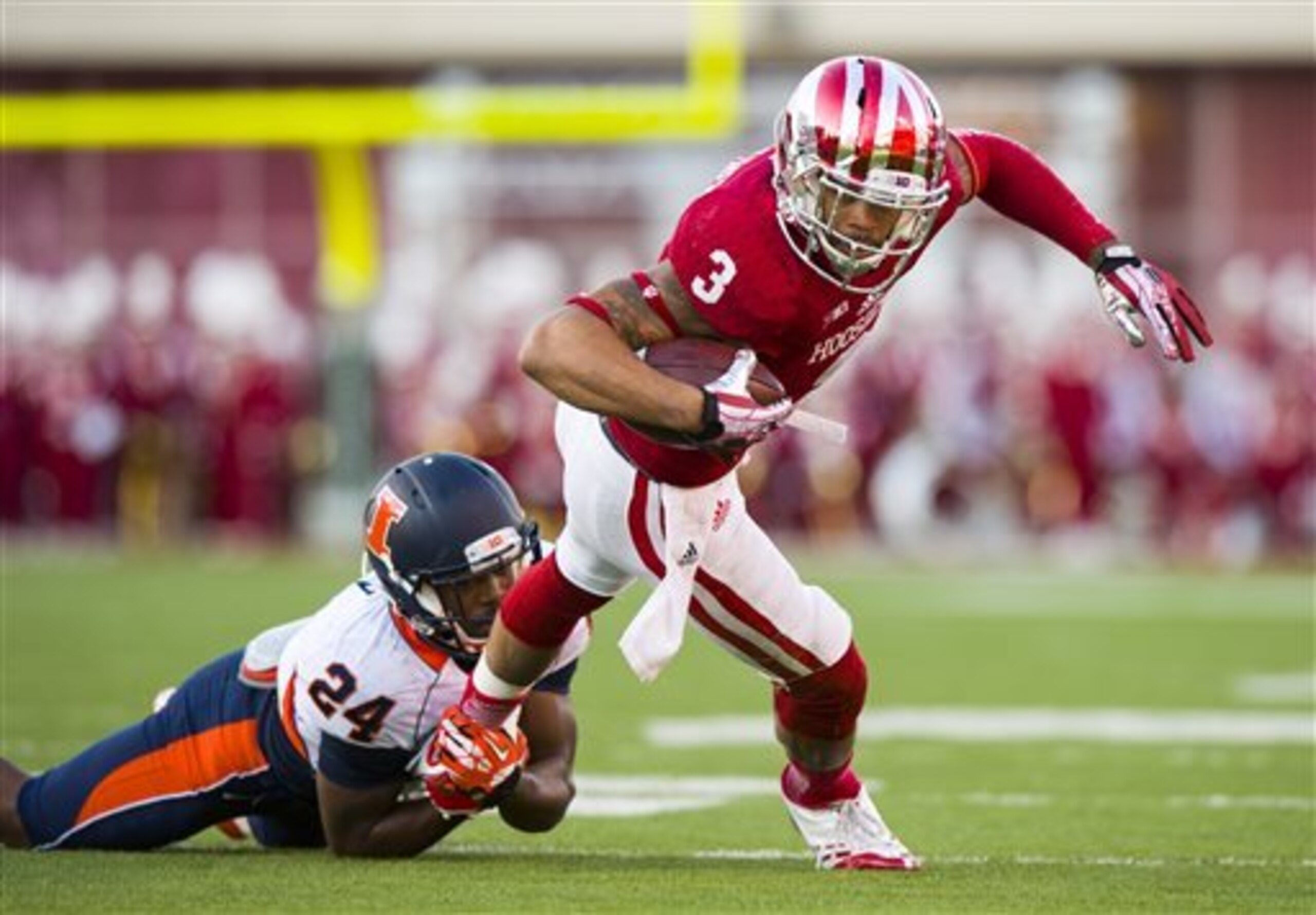 Indiana's Cody Latimer (3) is tackled by Illinois' Darius Mosely (24) during the first half of an NCAA college football game, Saturday, Nov. 9, 2013, in Bloomington, Ind. (AP Photo/Doug McSchooler)