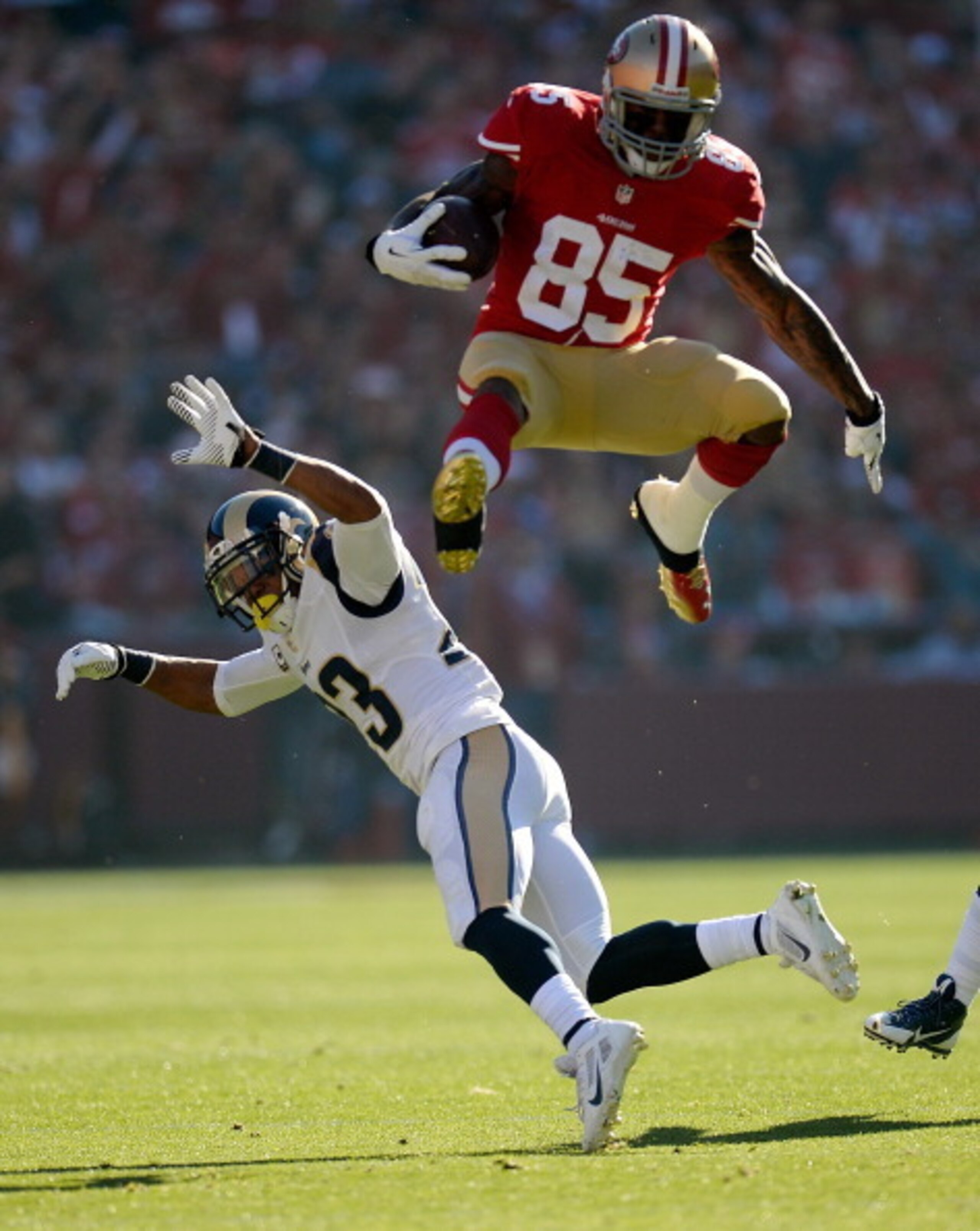 SAN FRANCISCO, CA - DECEMBER 01:  Vernon Davis #85 of the San Francisco 49ers leaps over would be tackler Rodney McLeod #23 of the St. Louis Rams during the first quarter at Candlestick Park on December 1, 2013 in San Francisco, California.  (Photo by The