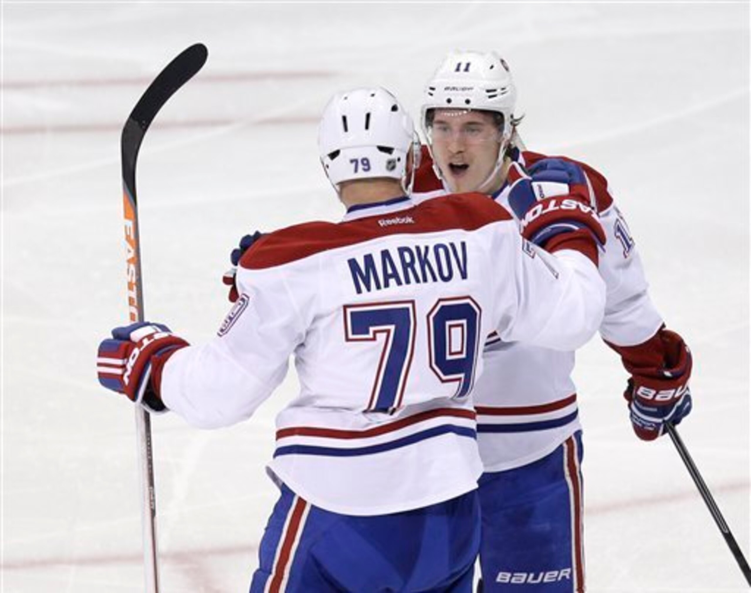 Montreal Canadiens defenseman Andrei Markov celebrates a goal with forward Brendan Gallagher.
