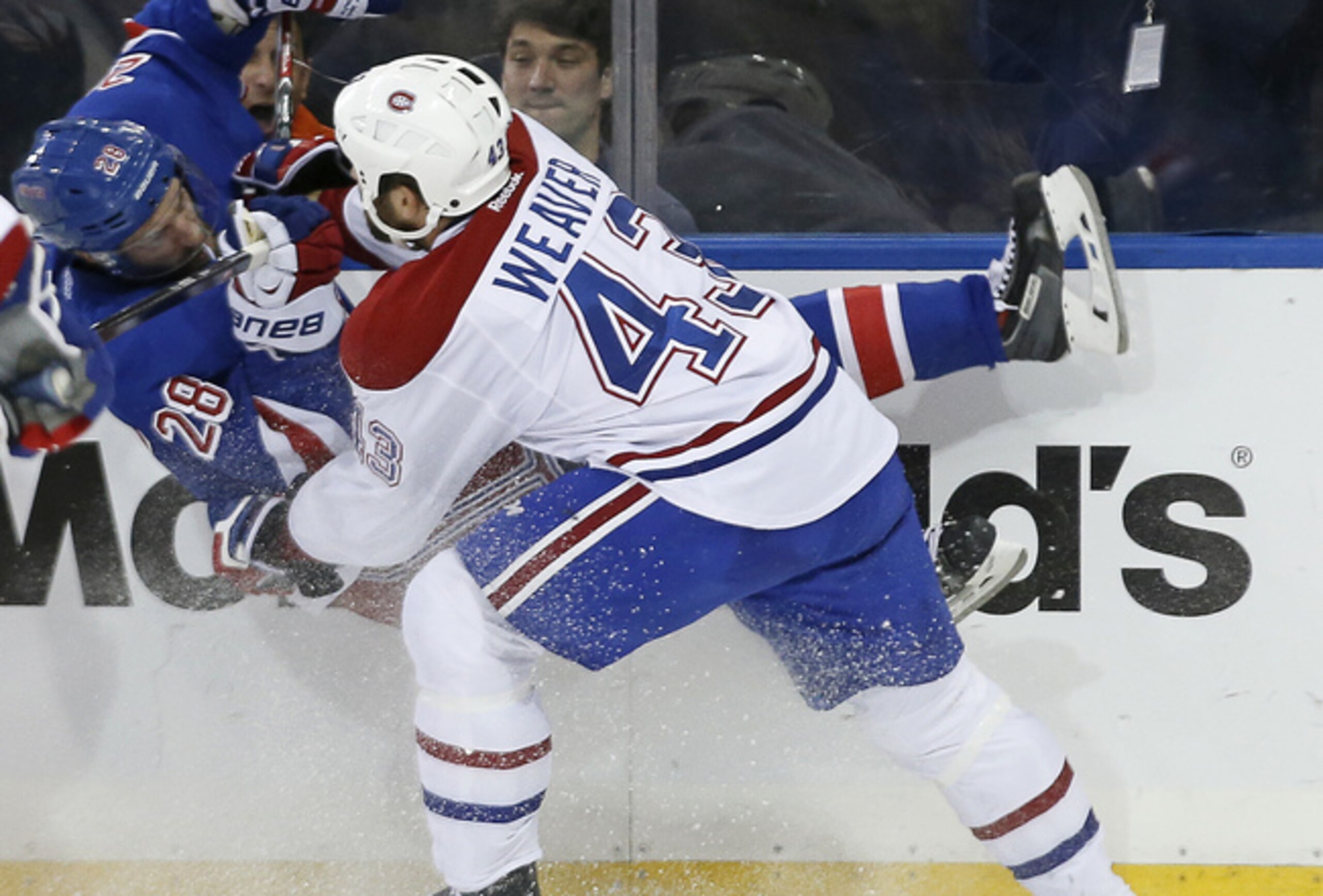 Montreal Canadiens defenseman Mike Weaver takes out New York Rangers forward Dominic Moore.