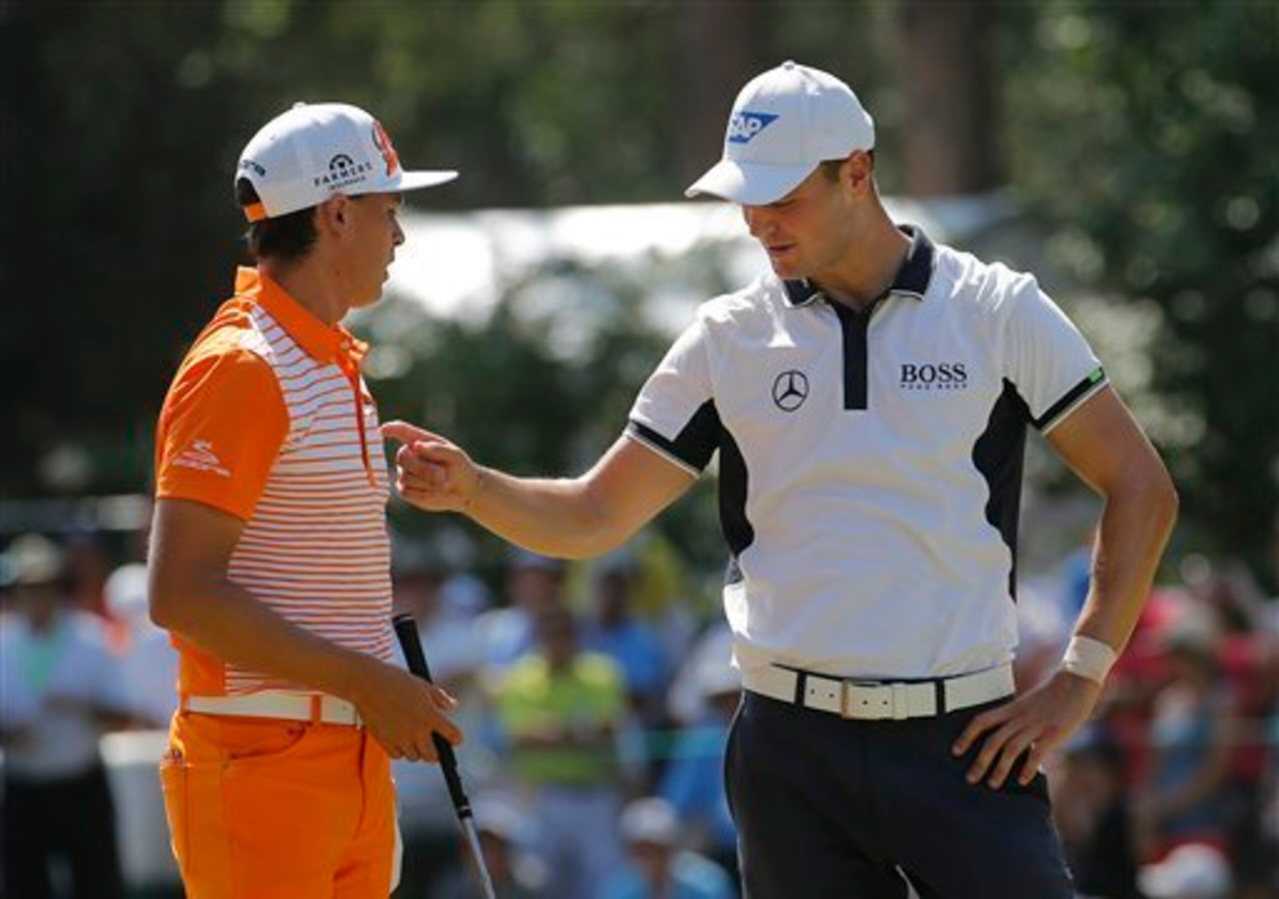 Martin Kaymer checks out Rickie Fowler's Sunday outfit.