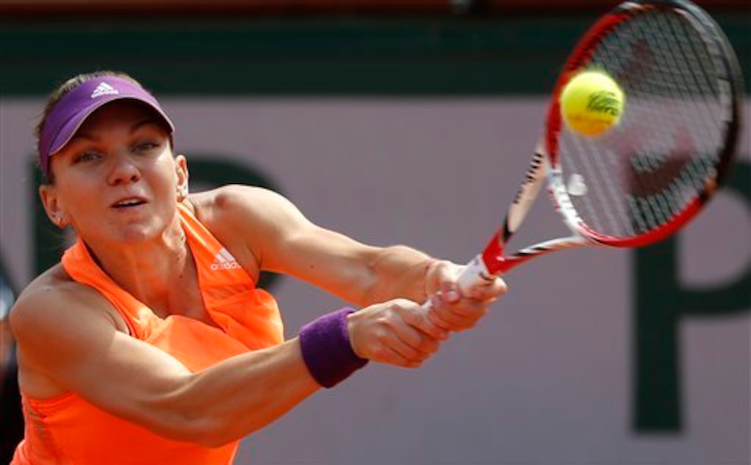 Simona Halep reaches for a backhand during the finals of the 2014 French Open.