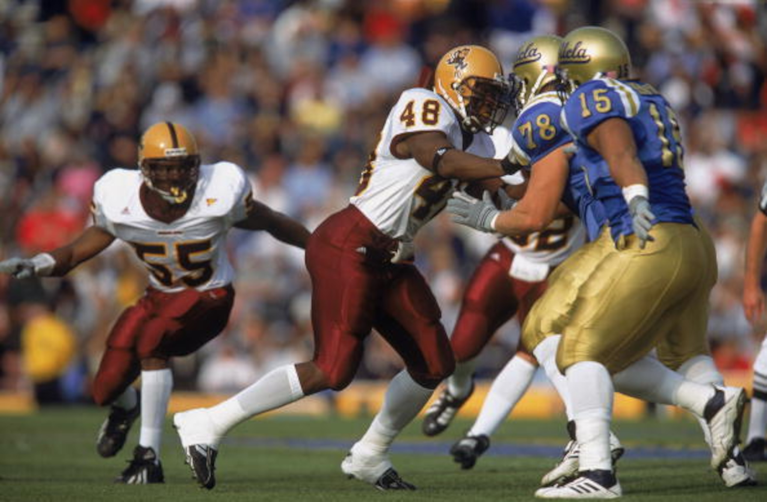 1 Dec 2001:  Terrell Suggs #48 of the Arizona State Sun Devils wrestles Bryce Bohlander #78 of the UCLA Bruins during the Pac-10 Conference football game at the Rose Bowl in Pasadena, California.  The Bruins defeated the Sun Devils 52-42.Mandatory Credit: