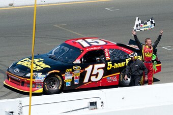 Clint Bowyer waves the checkered flag after winning at Sonoma in 2012.