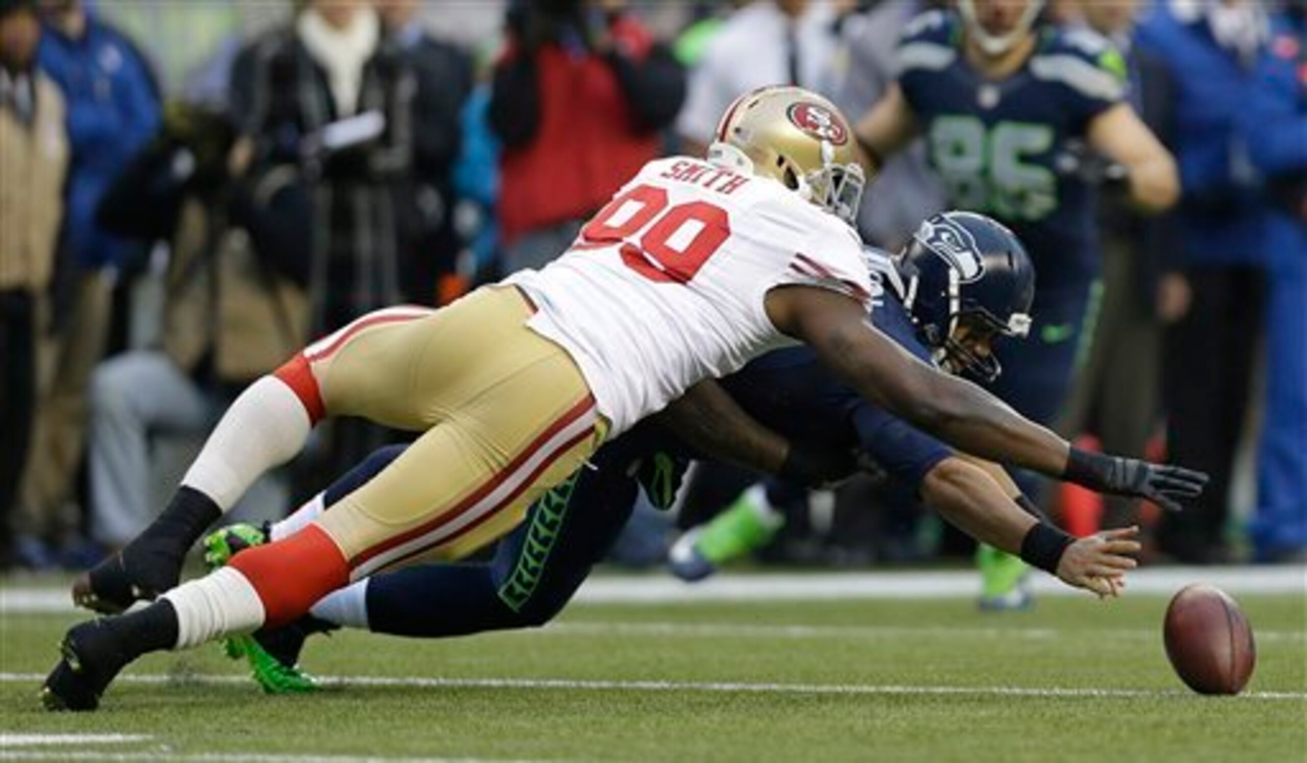 Aldon Smith strip-sacks and recovers Russell Wilson's fumble on the very first play of the 2013 NFC Championship Game.