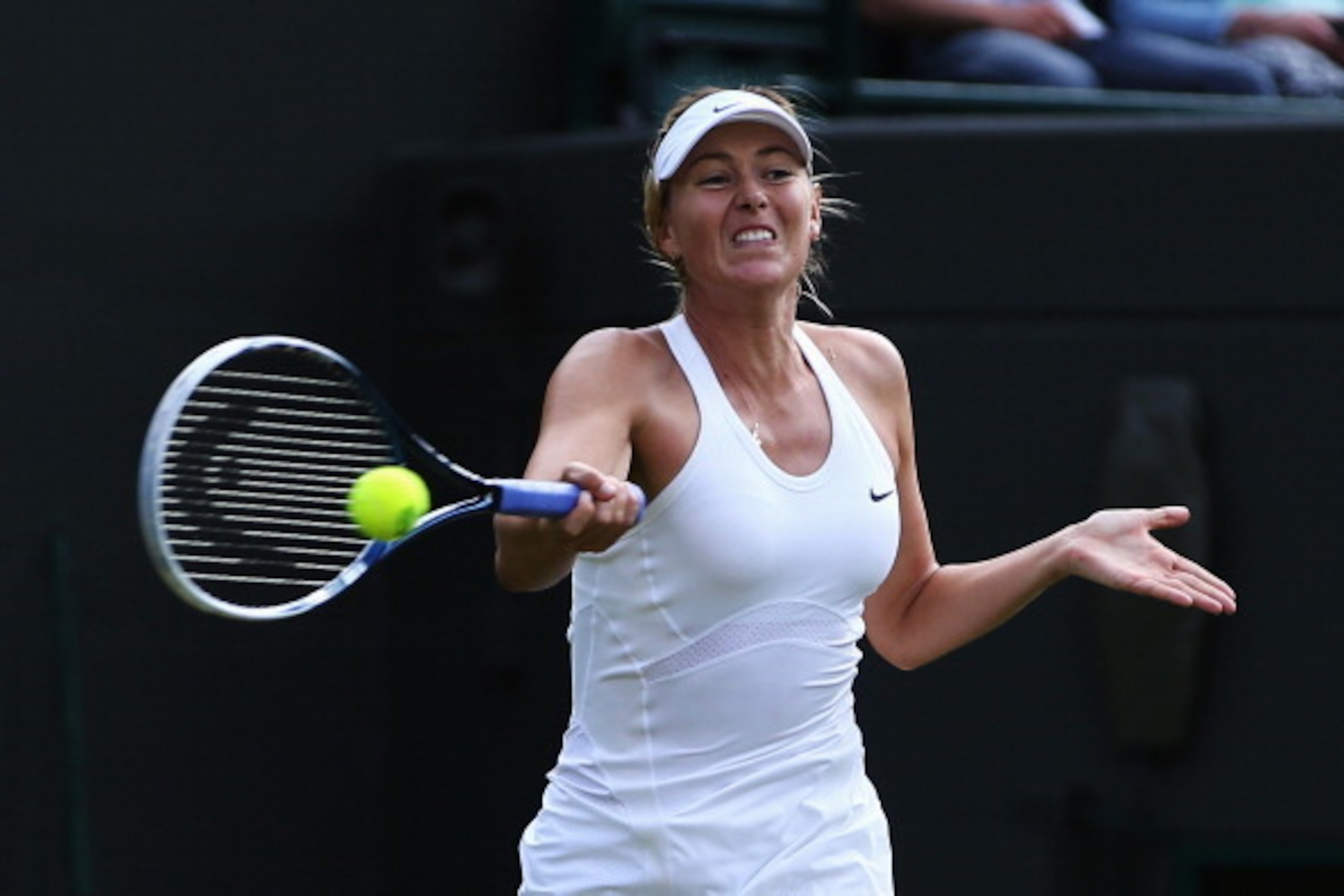 Maria Sharapova hits a forehand during her first-round match at 2014 Wimbledon.