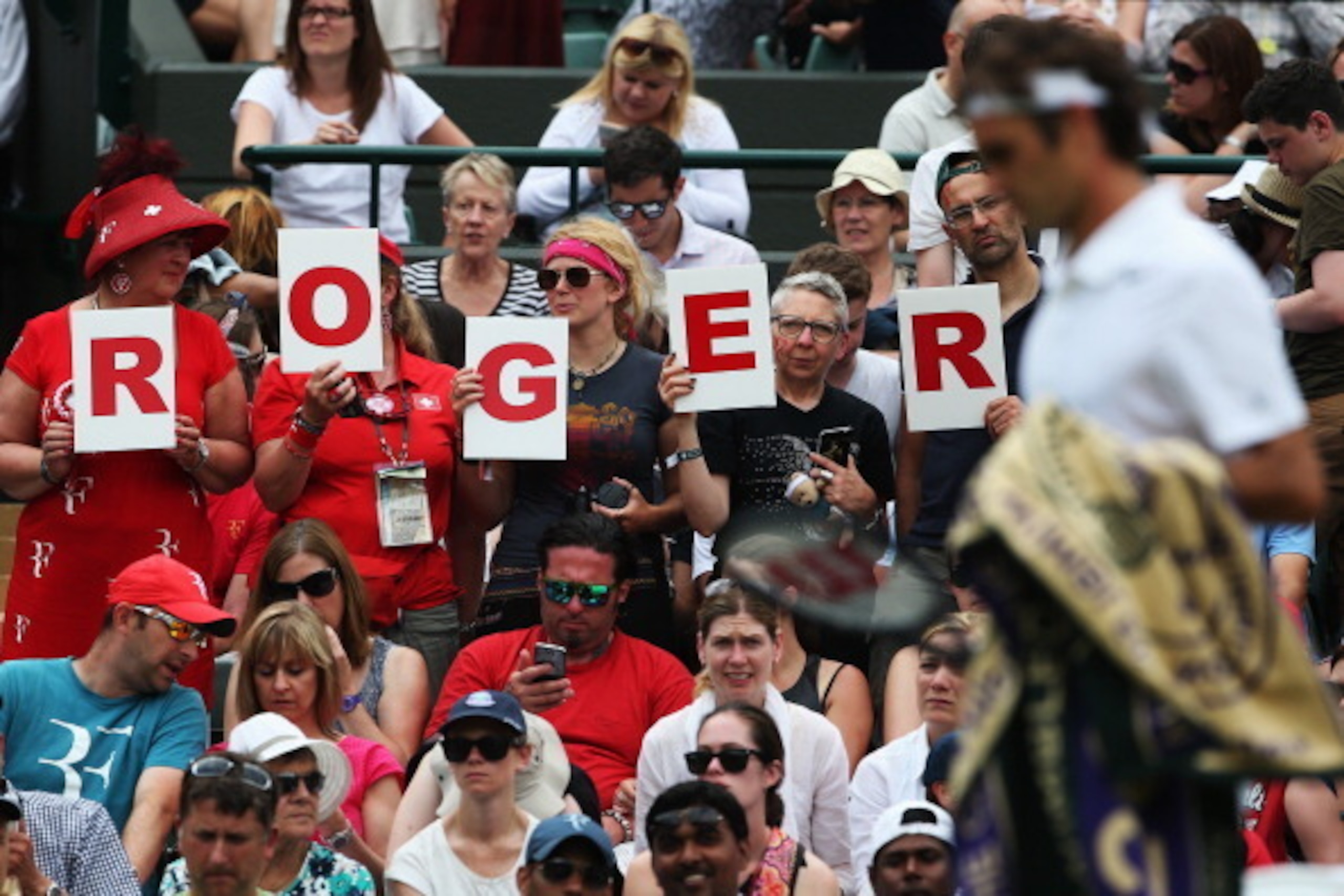 Wimbledon fans cheer on Roger Federer during his opening round match.