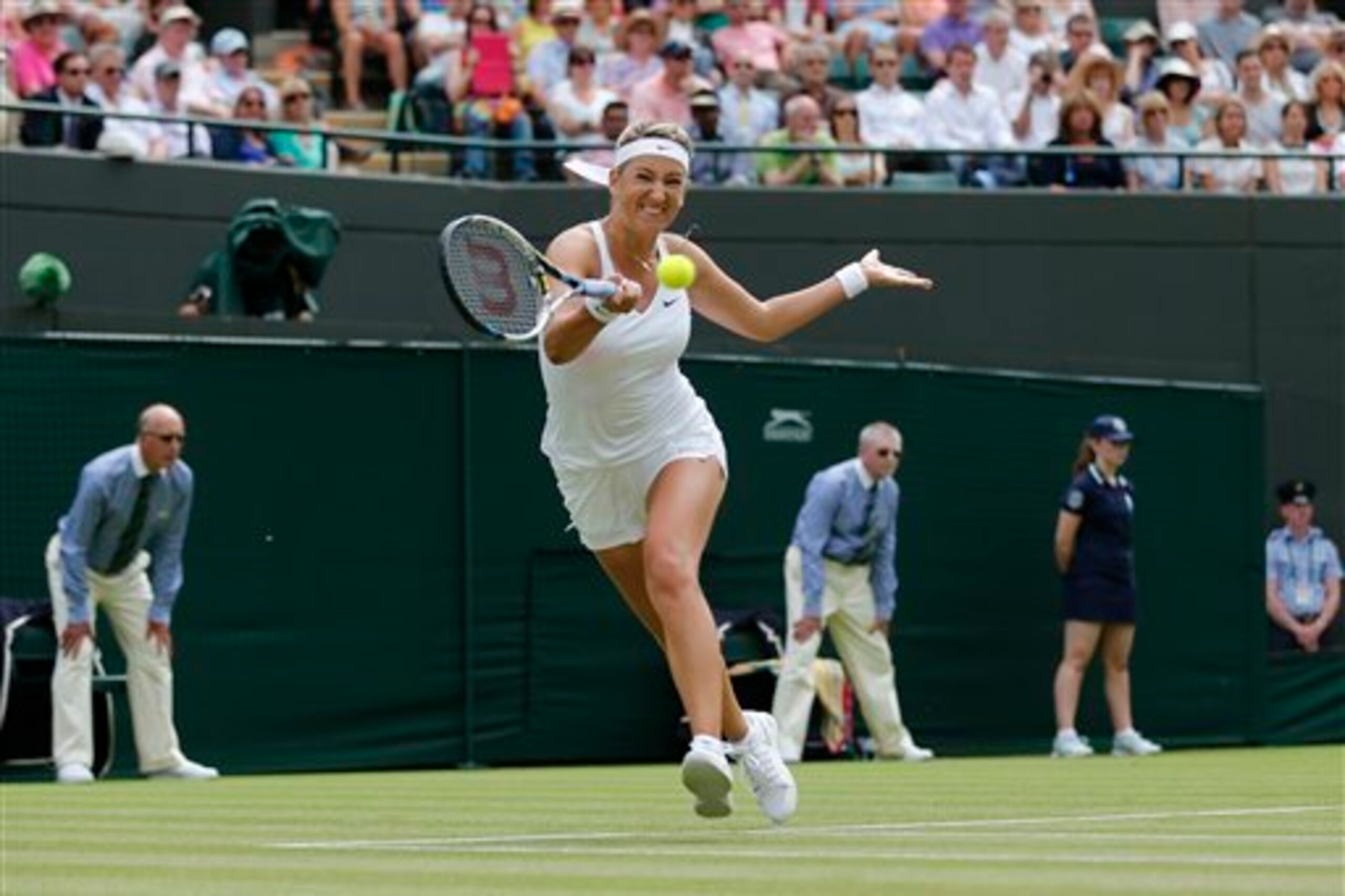 Victoria Azarenka hits a forehand during first-round match at Wimbledon 2014.