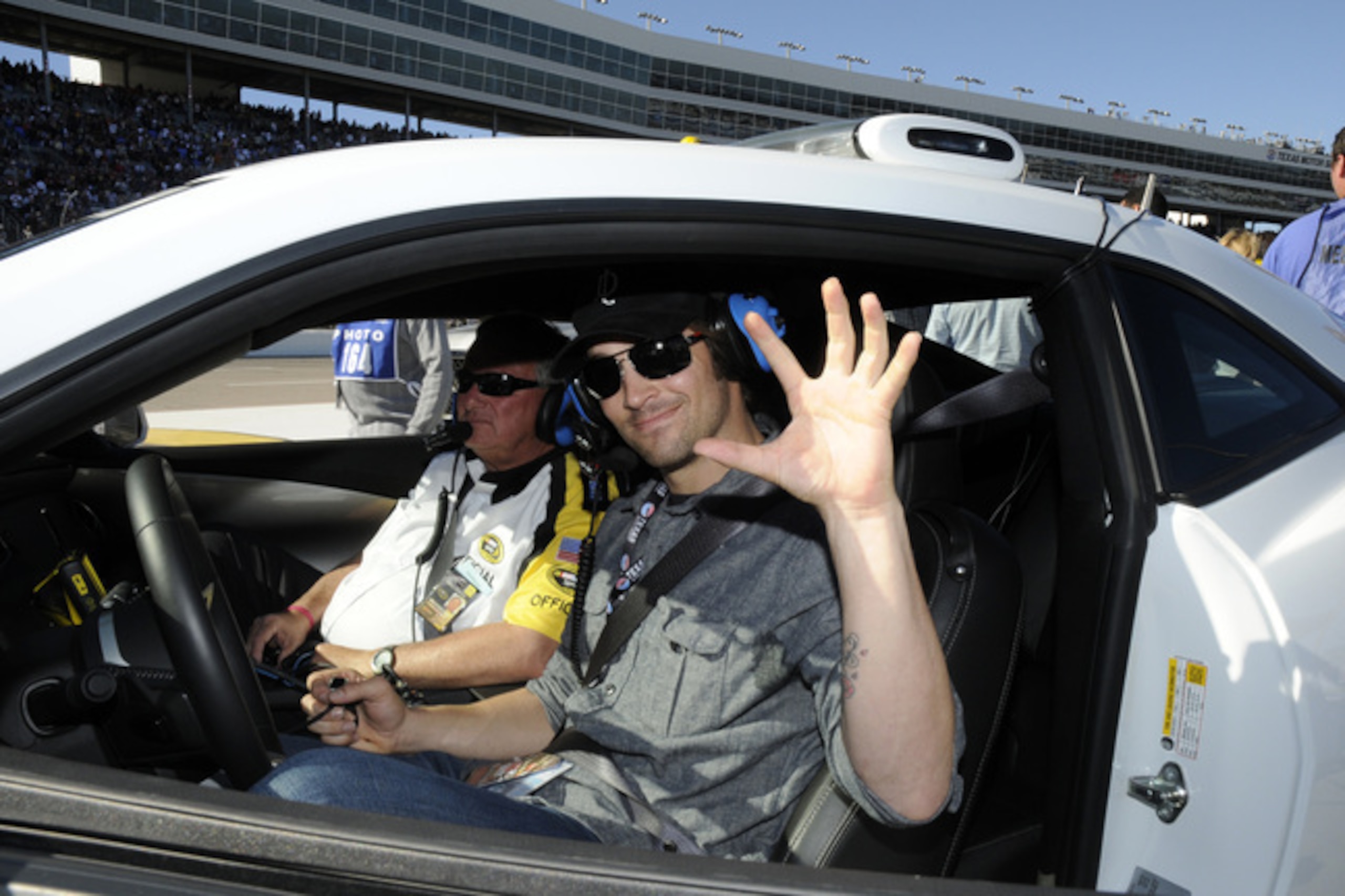 Current Angels and former Rangers pitcher C.J. Wilson shows the claw at a NASCAR event.