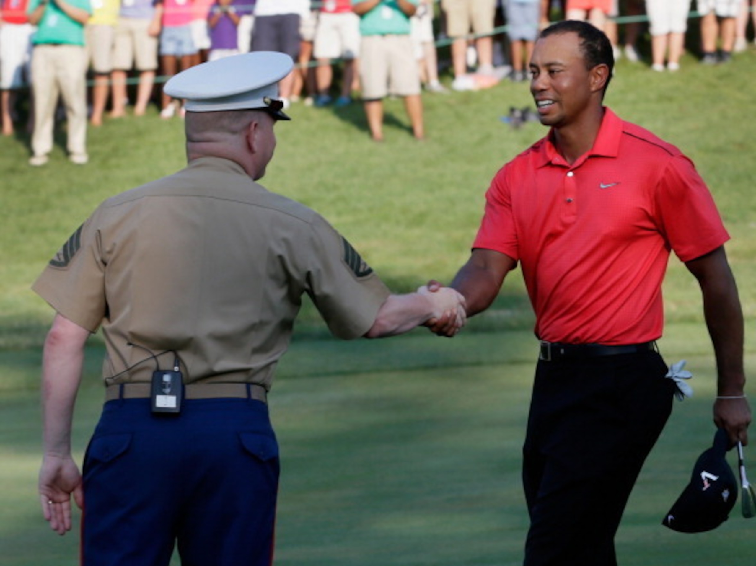 Tiger Woods greets a Marine at the National.