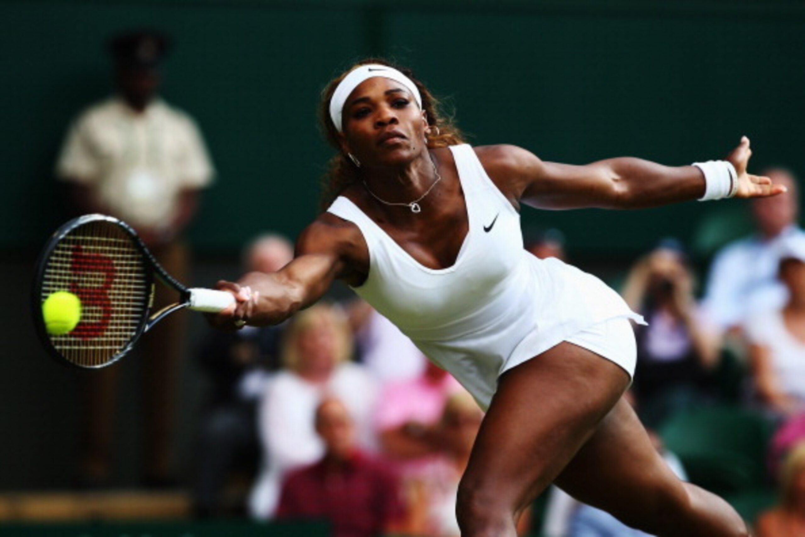 Serena Williams reaches for the ball during her first-round match at 2014 Wimbledon.