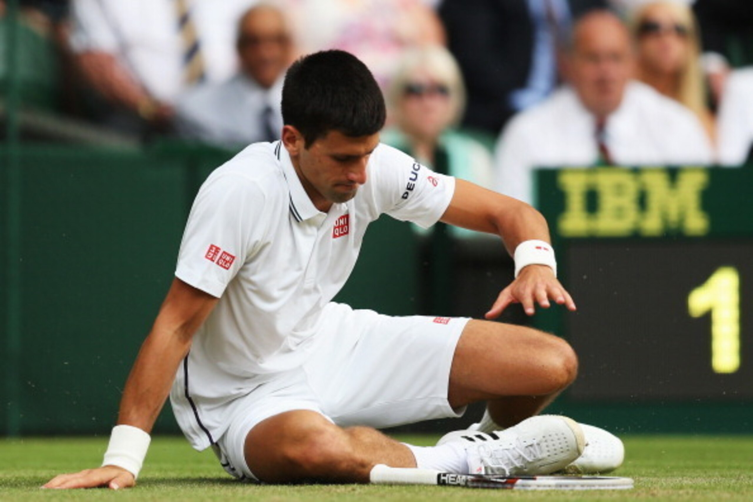 Novak Djokovic gets up from a fall during his second-round match at Wimbledon.