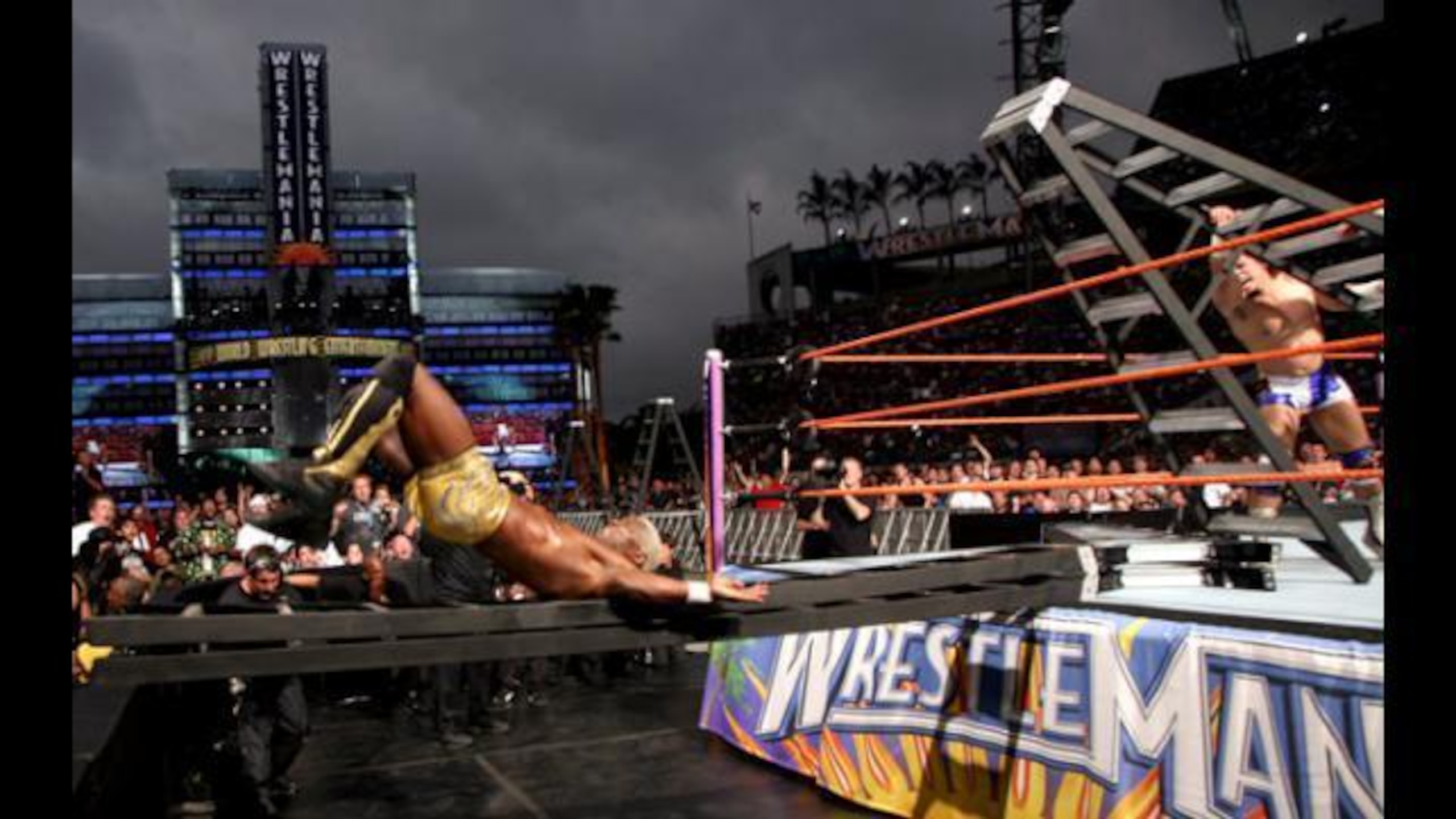 Shelton Benjamin is sent spiraling through a ladder at ringside.